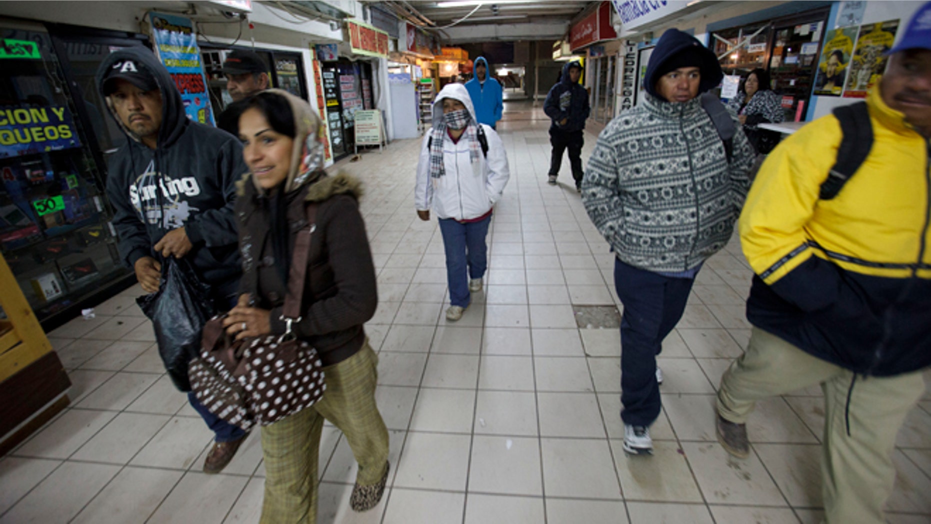 FILE - In this March 7, 2012 file photo, people make their way towards the border to cross in Mexicali, Mexico. More Mexicans are leaving the United States than coming to the country, marking a reversal to one of the most significant immigration trends in U.S. history, according to a study published Thursday, Nov. 19, 2015. (AP Photo/Gregory Bull)