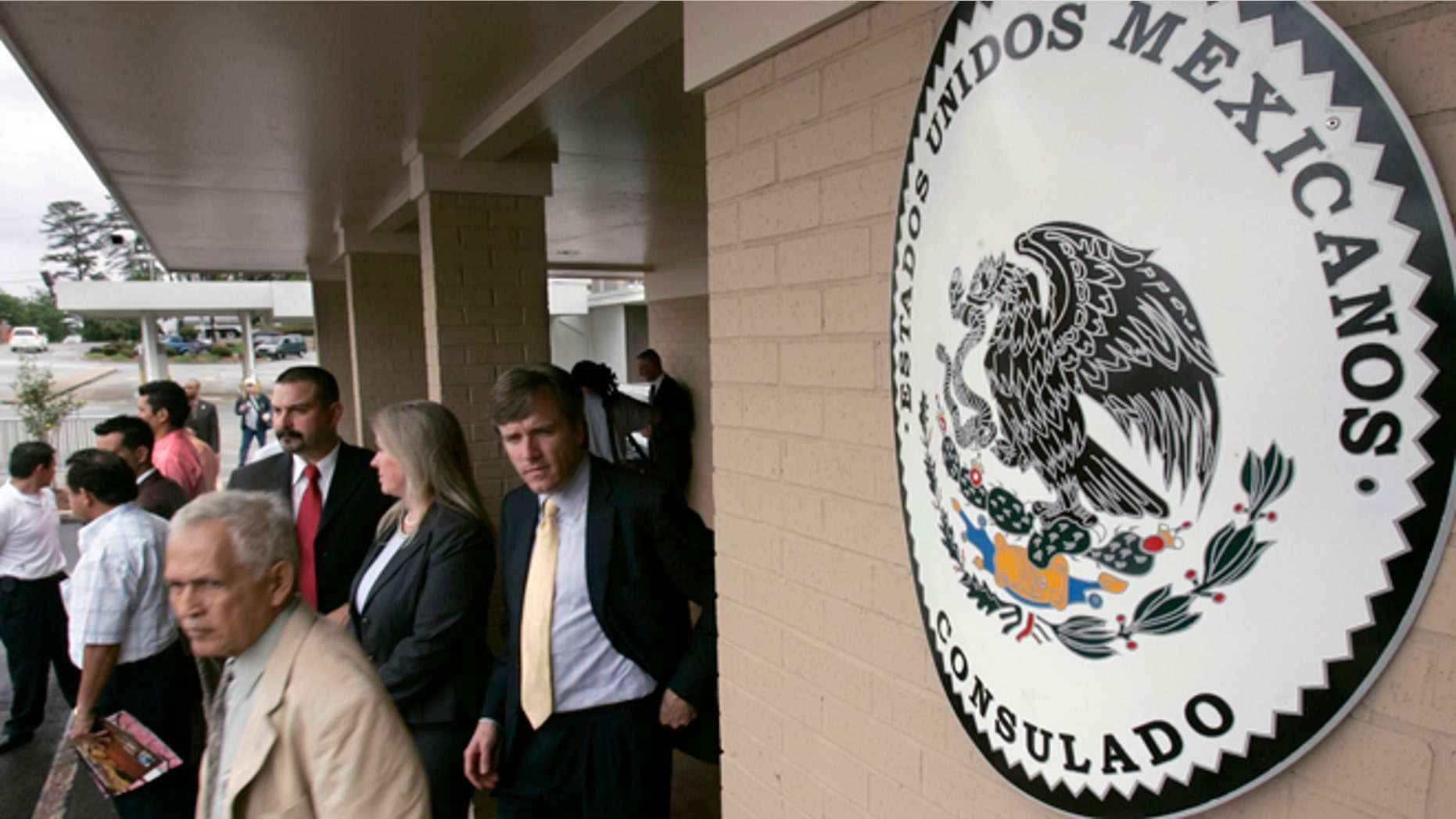 FILE - Visitors walk from the Mexican Consulate in Little Rock, Ark., after the grand opening of the building in this Wednesday, April 25, 2007 file photot. The Mexican government on Thursday Jan. 15, 2015 will start issuing birth certificates to its citizens at consulates in the United States, seeking to make it easier for them to apply for U.S. work permits, driver's licenses and protection from deportation. (AP Photo/Danny Johnston, File)