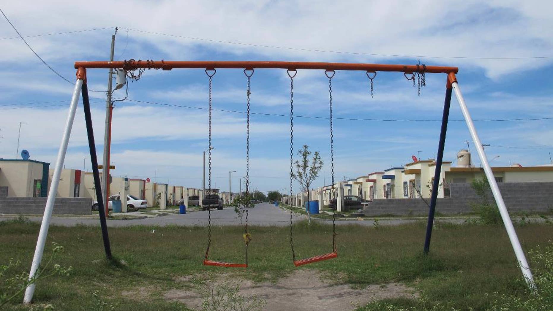 In this April 9, 2014 photo, a playground stands empty in the San Pedro subdivision on the outskirts of Matamoros, in Mexico's state of Tamaulipas. Of four women interviewed in this working-class neighborhood, none would give their names. One said her husband was taken by gunmen 2 ½ years ago. Another said it had been three years since her 28-year-old son disappeared. Yet another recounted when a marine helicopter opened fire from the air, sending residents scrambling for cover. (AP Photo/Christopher Sherman)