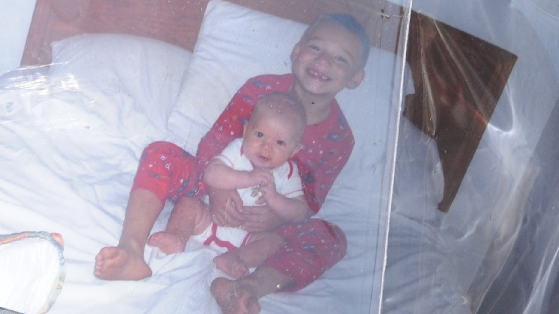 A 2008 photo of fire victim Damien Lopez, top, holding his half-brother, Izayah Lopez, who was not a fire victim. Lopez's father, Fidelmar "Fidel" Merlos-Lopez, a Mexican national was initially barred from entering the United States to bury his son.