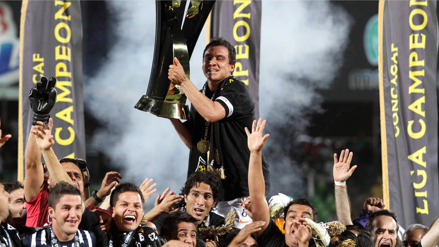 Mexico's Rayados de Monterrey Luis Perez, top, celebrates with teammates at the end of the CONCACAF Champions League final soccer match against Santos in Torreon, Mexico, Wednesday April 25, 2012. Rayados de Monterrey won 3-2 on aggregate. (AP Photo/Alberto Puente)