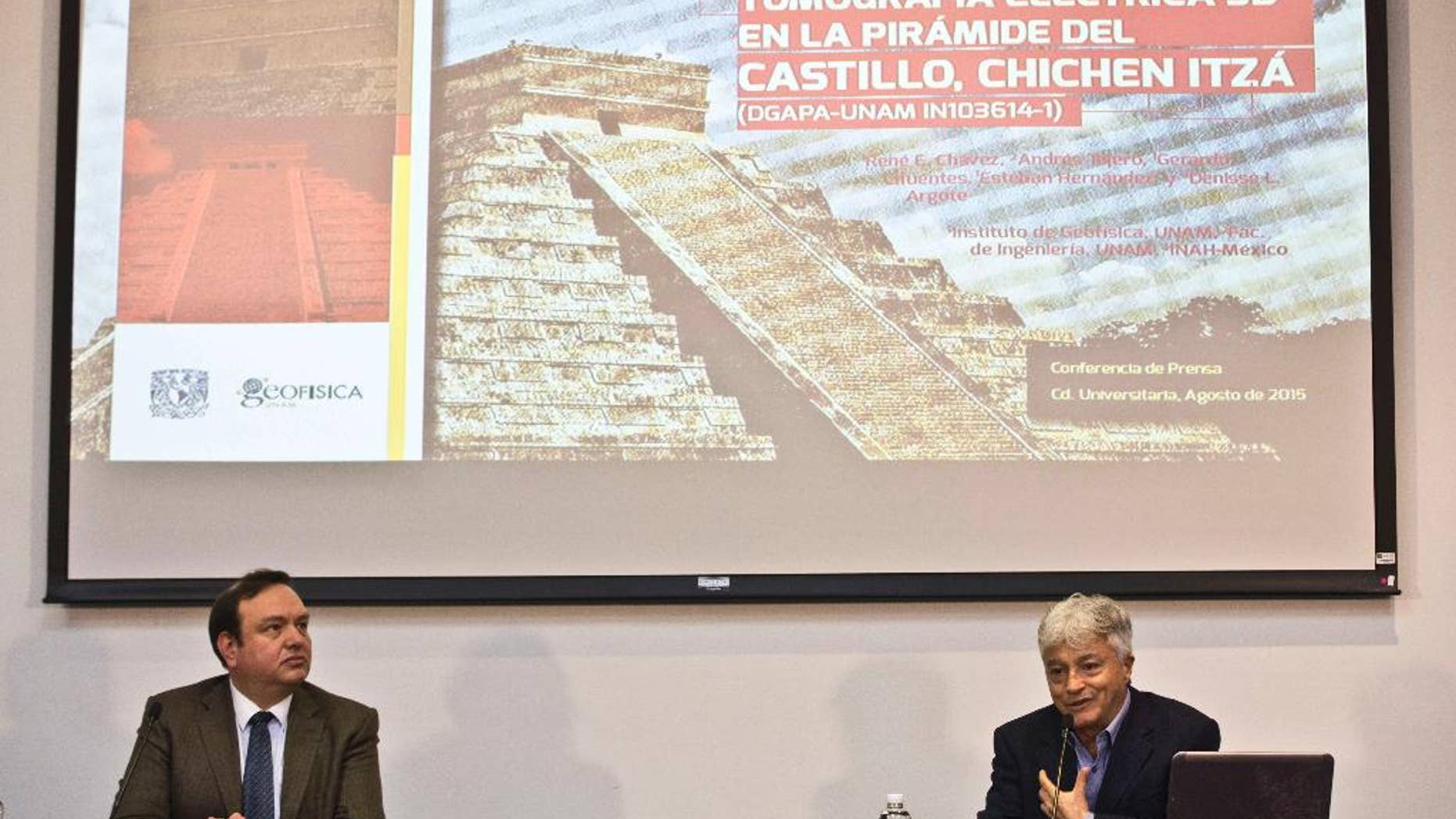 Rene Chavez, right, researcher at the Institute of Geophysics of the National Autonomous University of Mexico, (UNAM), speaks next to Arturo Iglesias, director of the Institute, during a press conference in Mexico City, Thursday, Aug. 13, 2015. Researchers at the UNAM found that the Kukulcan pyramid in the archaeological site of Chichen Itza is built on a cenote or a water filled sinkhole. (AP Photo/Esteban Felix)