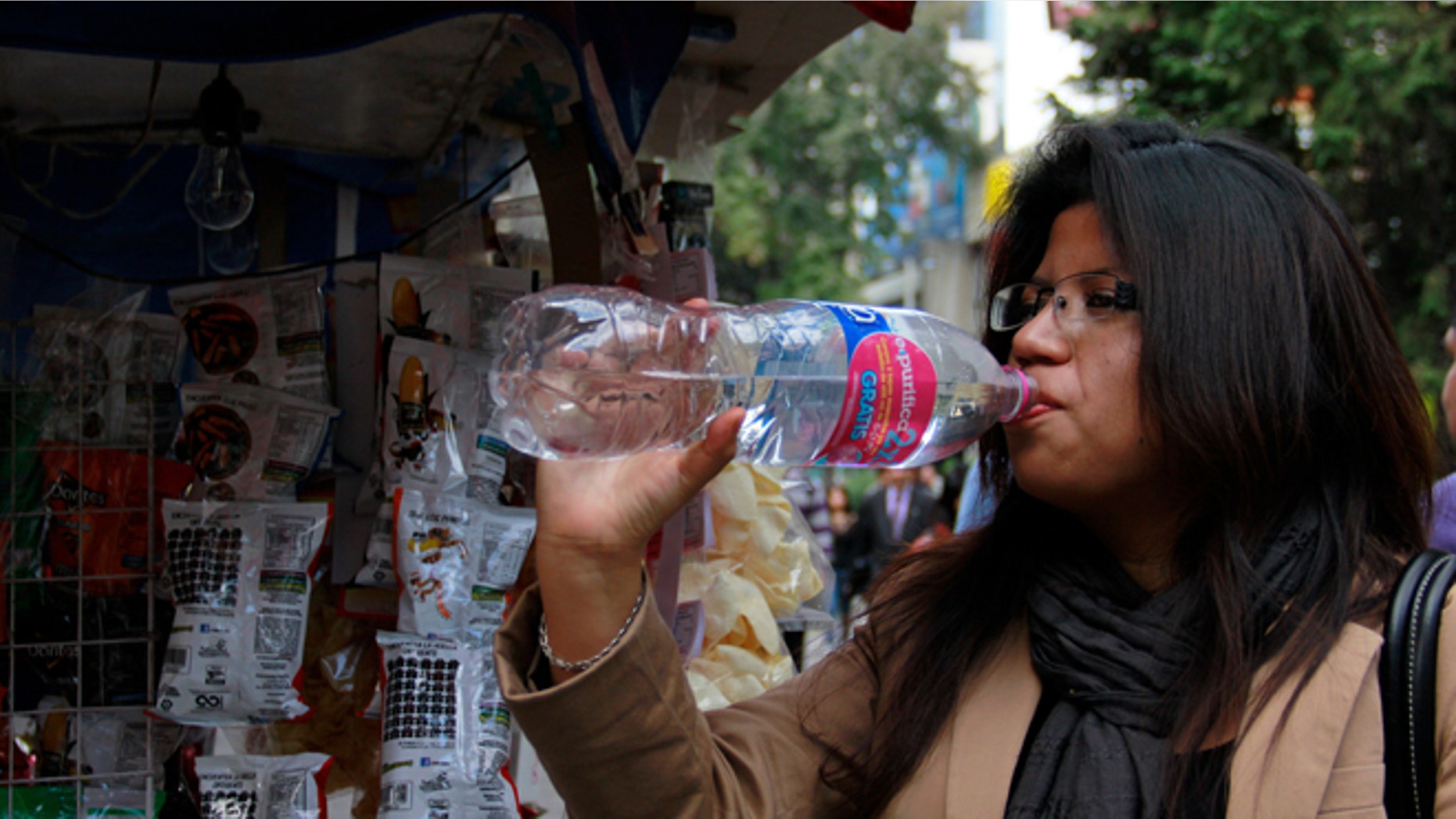 In this Jan. 9, 2014 photo, a woman drinks bottled water in Mexico City. Bad tap water accounts in part for Mexico being the highest consumer of bottled water and sweetened drinks. A law recently approved by Mexico Cityâs legislators will require all restaurants to install filters, offering patrons free, apparently drinkable potable water that wonât lead to stomach problems and other ailments. With an obesity epidemic looming nationwide, the cityâs health department decided to back the water initiative. (AP Photo/Marco Ugarte)