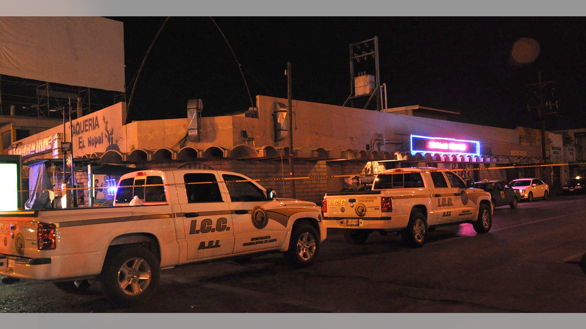 Aug. 14, 2012: Police forensic investigation vehicles sit parked outside Matehuala Men's Club after a shooting inside the night club in Monterrey, Mexico.
