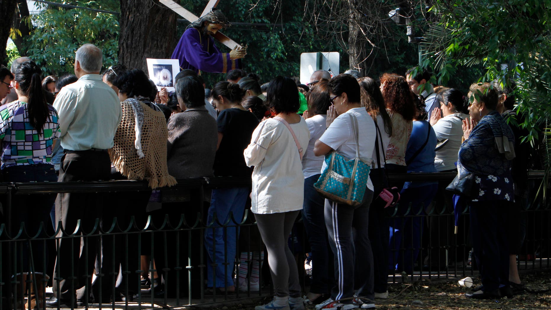 April 18, 2014 - People who were participating in a Holy Week procession stop and pray after a strong earthquake jolted Mexico City, Friday. There were no early reports of major damage or casualties.