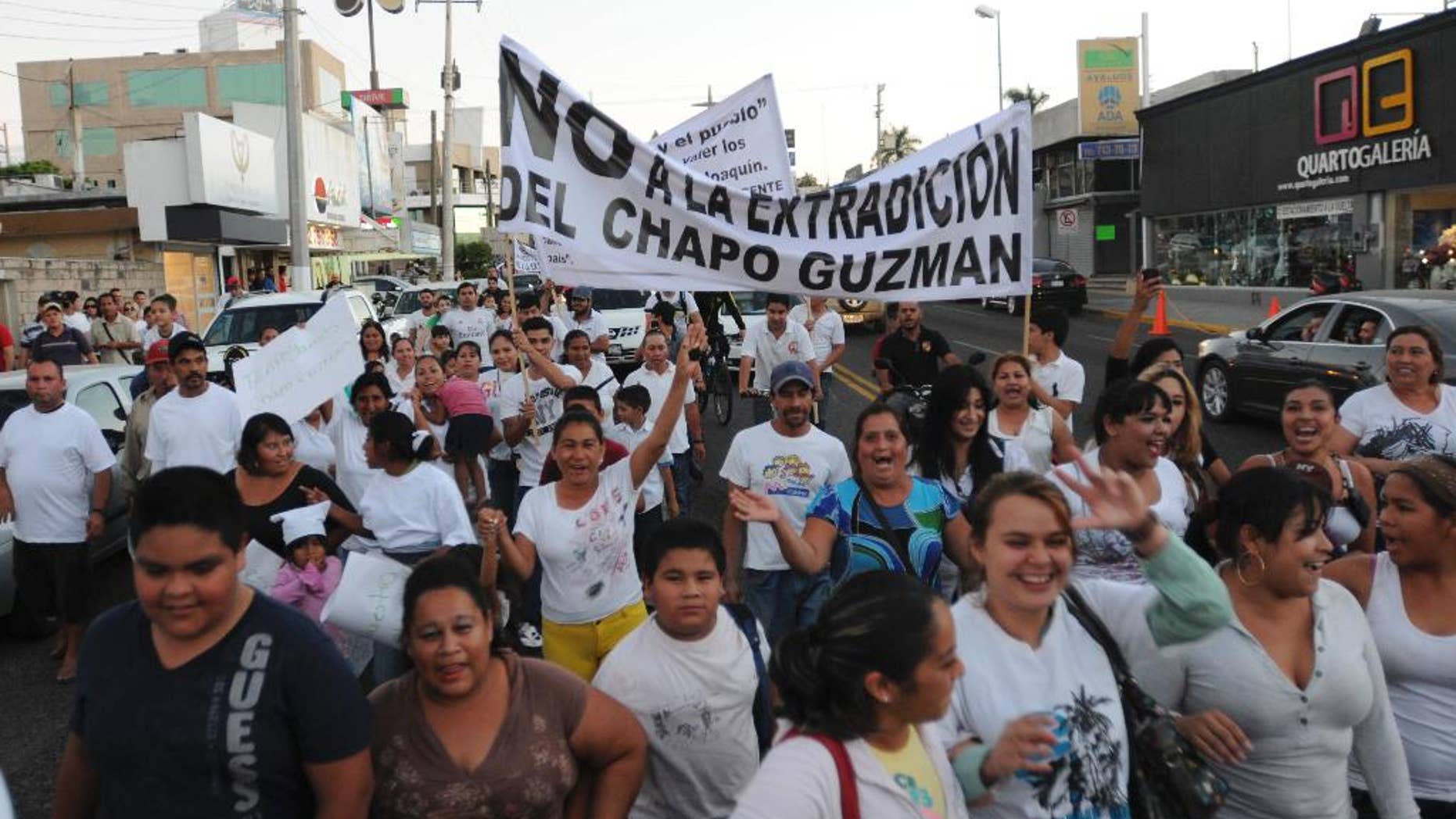 FILE - In this Feb. 26, 2014 file photo, people march in support of jailed drug boss Joaquin Guzman, "El Chapo," in the city of Culiacan, Mexico. Hundreds marched in the streets of the drug lord's bastion, demanding that Guzman be freed. Guzman, the one they called "shorty" because of his 5'6" frame grew up poor and had no formal education, would rise from a small-time Mexican marijuana producer to lead the world's most powerful drug cartel. (AP Photo/El Debate de Culiacan, Jonathan Telles, File)