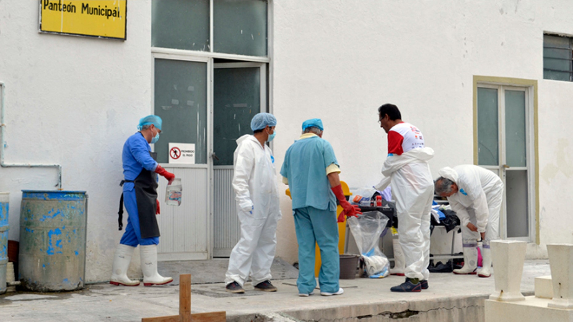 Forensic workers at a morgue inside the cemetery of the city of Tehuacan, Mexico, Saturday, June 11, 2016.