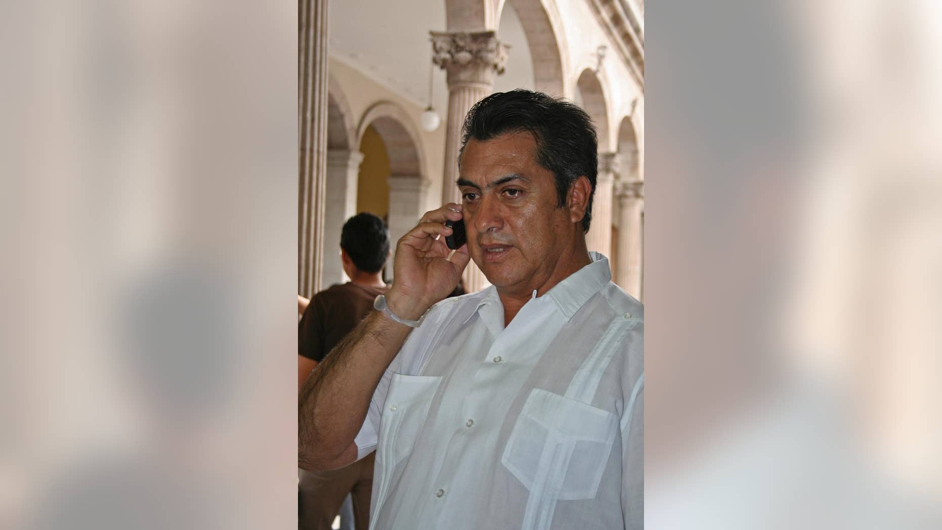 FILE - In this March 30, 2011 file photo, Jaime Rodriguez, mayor of the Mexican town Villa Garcia, speaks on a cellphone in Monterrey, Mexico, a day after he survived an assassination attempt. As mayor of a suburb of the northern industrial city of Monterrey, Rodriguez survived two assassination attempts that left his car bullet-ridden, defying, he says, the fierce Zetas cartel. Now he is trying to beat the odds in another way, running as an independent for governor of Nuevo Leon, a wealthy and strategic state bordering Texas. (AP Photo, File)