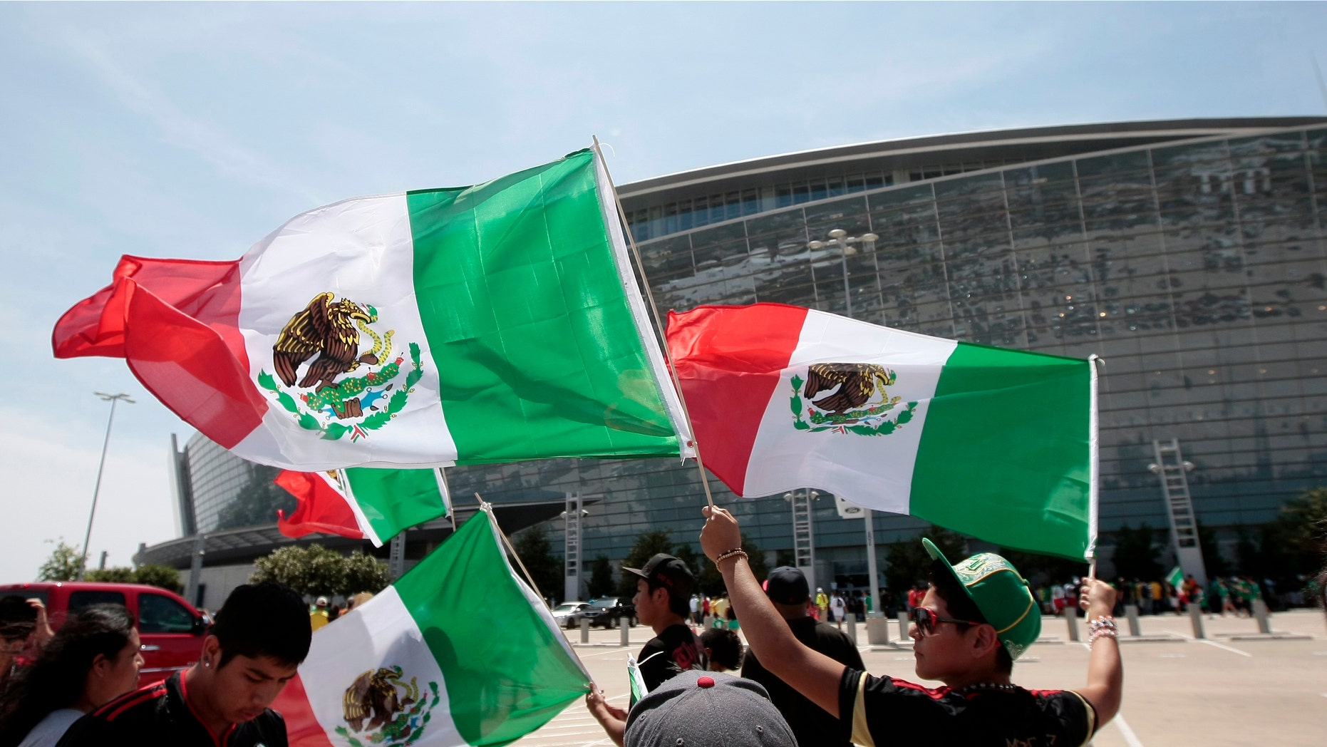 ARLINGTON, TX - JUNE 03: Mexico fan wave their flags before a soccer game against Brazil at Cowboys Stadium on June 3, 2012 in Arlington, Texas. Mexico won 2-0. (Photo by Brandon Wade/Getty Images)