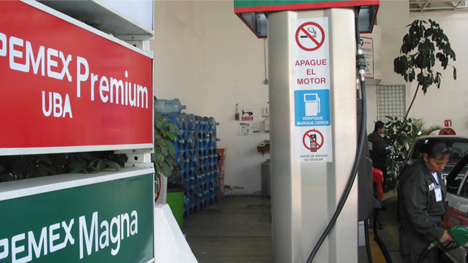 An attendant at a Mexico City gas station fills up a car on July 28, 2008. Mexican gas stations carry the Pemex name, but a lack of investment has left Mexico a net importer of gasoline. (Kevin G. Hall/MCT)