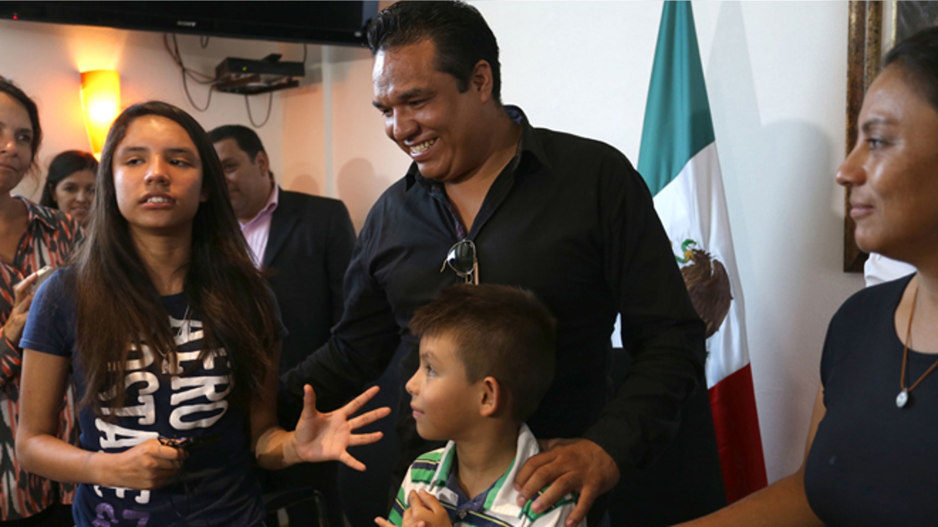 Alondra Luna Nunez, left, gets up after giving a press conference with her parents Gustavo Luna and Susana Nunez after landing at the Guanajuato International Airport in Silao, Mexico, Wednesday, April 22, 2015. The 14-year-old Mexican girl, who was taken from her school by police and sent kicking and screaming to the U.S., returned home after DNA tests showed she is not related to an American woman searching for her missing daughter. There was no immediate explanation of why authorities did not confirm her identity before sending her out of the country. (AP Photo/Mario Armas)