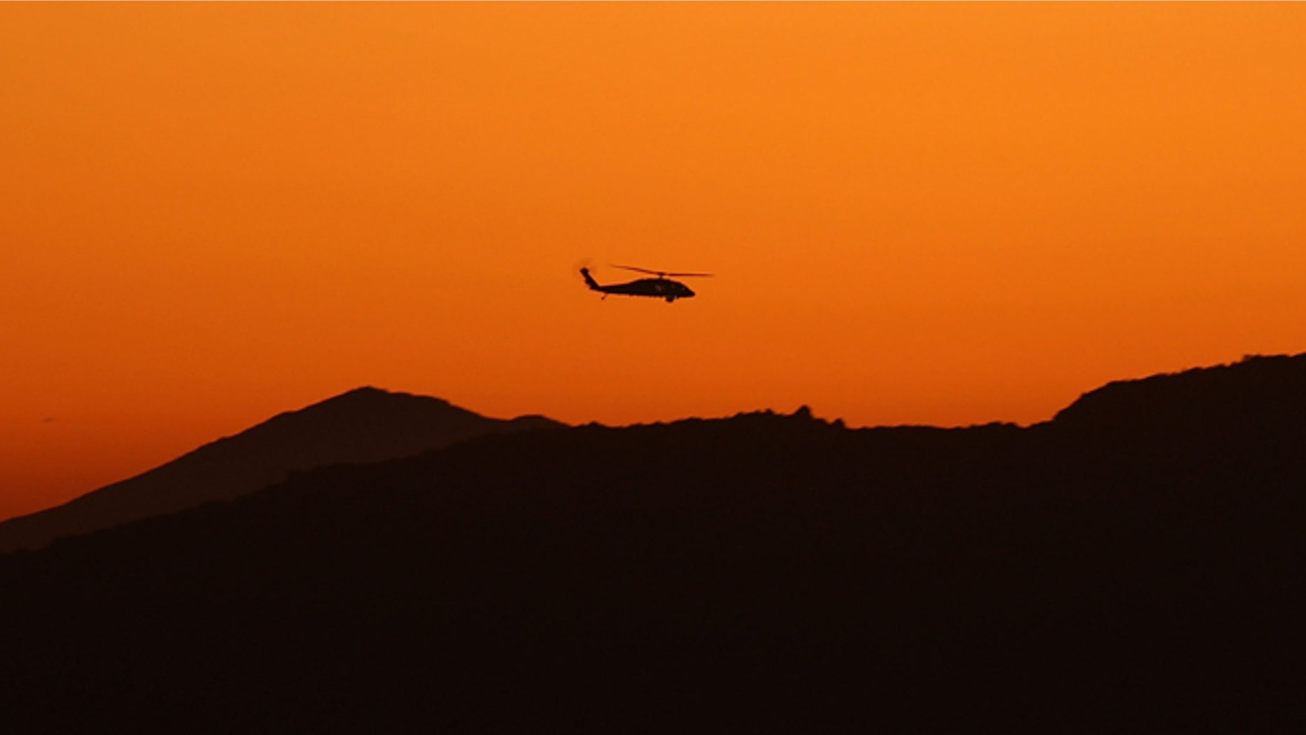 CAMPO, CA - JULY 29: A helicopter patrols the hills where US Border Patrol agents are carrying out special operations following the first fatal shooting of a US Border Patrol agent in more than a decade on July 29, 2009 near the rural town of Campo, some 60 miles east of San Diego, California. 30-year-old agent Robert Rosas was killed on July 23 when he tracked a suspicious group of people alone in remote brushy hills north of the border in this region. Violence has been escalating in Mexico with fights between well-armed drug cartels and the army becoming common since Mexican President Felipe Calderon began his army-backed war on the cartels. Since the conflict began in late 2006, 12,800 people have been killed. Mexican officials charge that guns which are easily smuggled in from the US have flooded into Mexico where gun laws are strict. (Photo by David McNew/Getty Images)