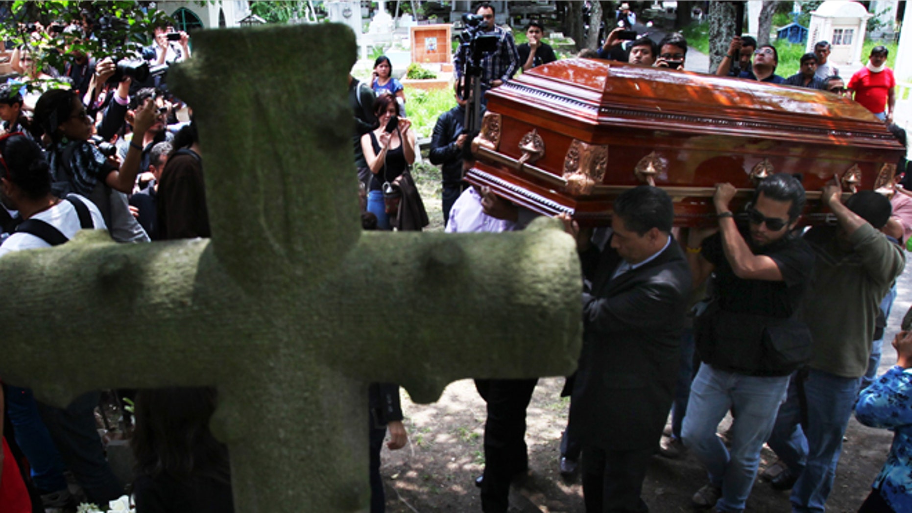 Men carry the casket of murdered photojournalist Rubén Espinosa during his funeral service in Mexico City, Monday, Aug. 3, 2015. With an investigation barely underway, Mexican journalist protection groups are already expressing fears that authorities won't consider Espinosa's brutal killing as being related to his work - even though he fled the state he covered fearing for his safety. Espinosa, 31, worked for the investigative magazine Proceso and other media in Veracruz state. (AP Photo/Marco Ugarte)