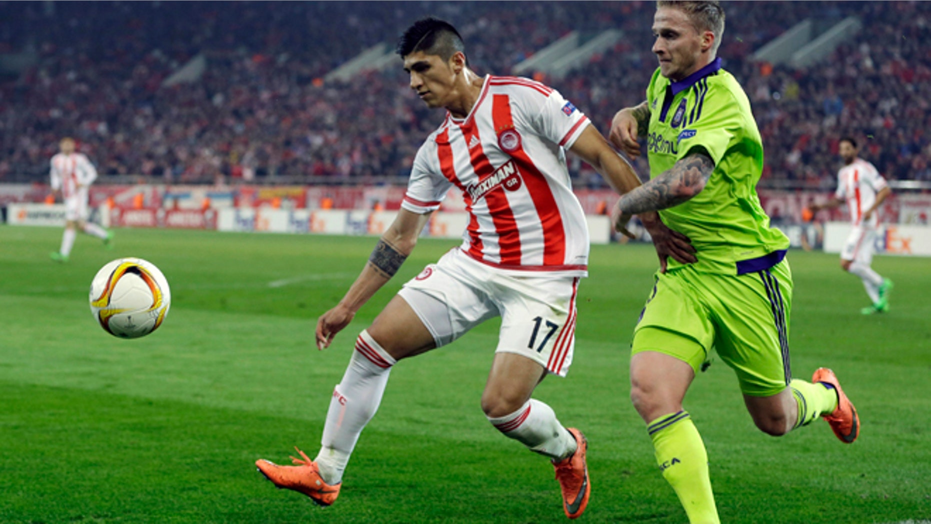 FILE - In this Thursday, Feb. 25, 2016 file photo, Olympiakos' Alan Pulido, left, fights for the ball with Anderlecht's Alexander Buttner during the Europa League round of 32 soccer match at the Georgios Karaiskakis stadium in the port of Piraeus, near Athens. A state official says that Mexican soccer star Alan Pulido has been kidnapped in the northern border state of Tamaulipas. Pulido is a forward for the Greek team Olympiacos and has made several appearances for Mexicos national team, though he wasnt called up for the upcoming Copa America tournament. The official says the 25-year-old player was kidnapped near his hometown of Ciudad Victoria on Sunday, May 29, 2016 after leaving a party. (AP Photo/Thanassis Stavrakis, file)