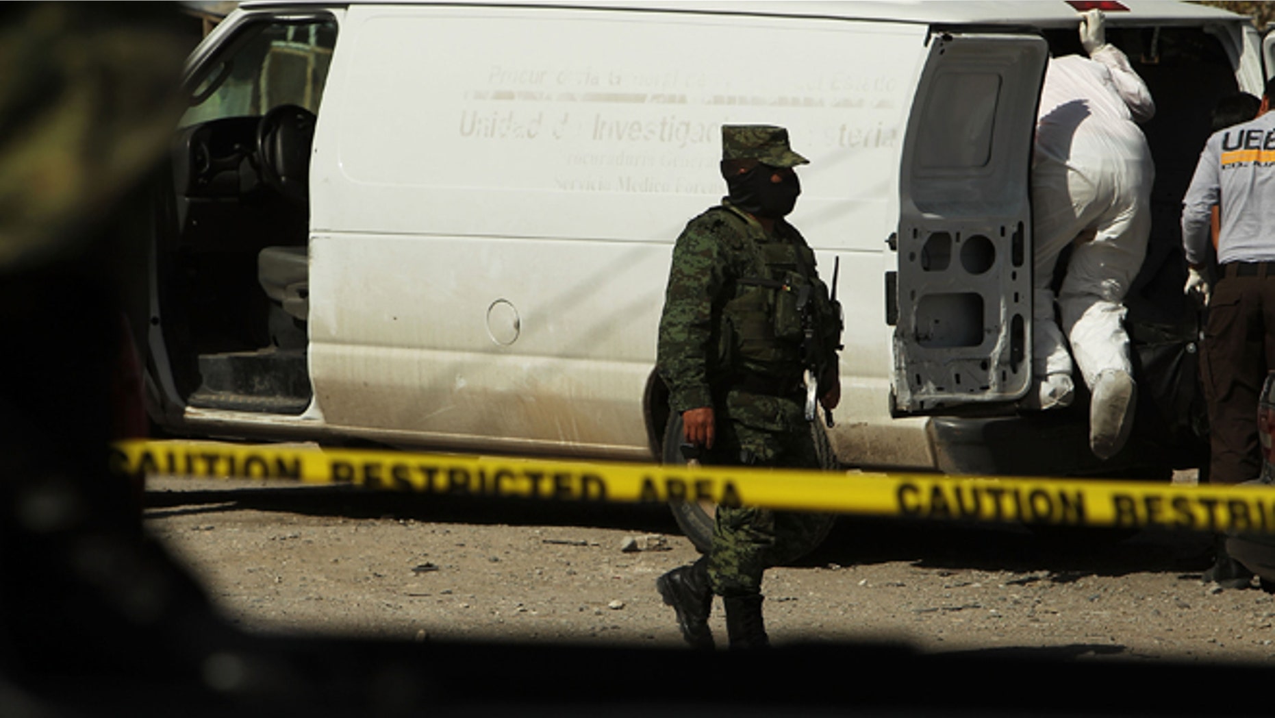 JUAREZ, MEXICO - MARCH 19: A Mexican soldier keeps guard near the site of a recent murder on March 19, 2010 in Juarez, Mexico. The border city of Juarez has been racked by violent drug-related crime, making it among the most dangerous cities in the world. As competing drug cartels fight over lucrative drug corridors along the U.S. border, the murder rate in Juarez has risen to 173 slayings for every 100,000 residents. President Felipe Calderon in 2009 disbanded the corrupt local police force and sent 10,000 soldiers to Juarez, but the violence has raged on. With a population of 1.3 million in Juarez, 2,600 died in drug-related violence last year and 500 so far this year, including two Americans who worked for the U.S. Consulate last weekend as they returned from a childrens party. (Photo by Spencer Platt/Getty Images)