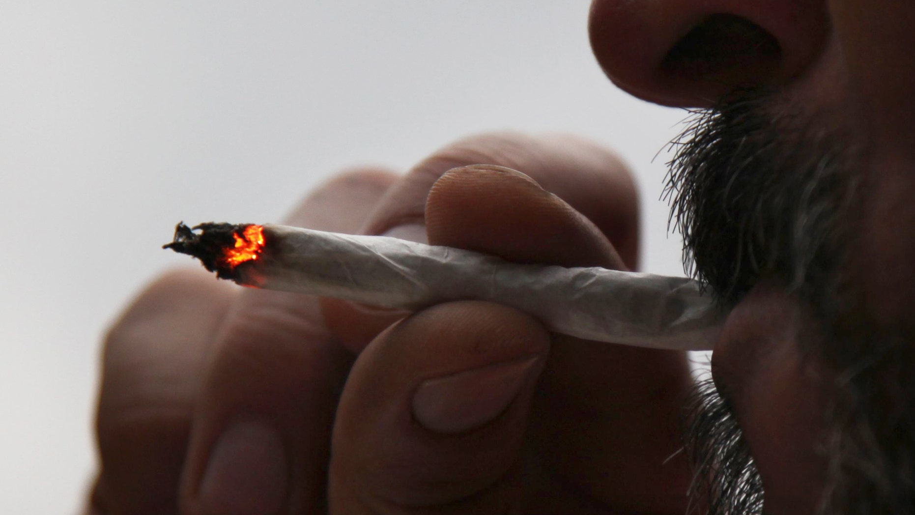 In this Aug. 4, 2013 photo, a man identified only as Pedro smokes a marijuana cigarette at his home in Mexico City. A group of leftist Mexico City lawmakers have introduced a bill, Thursday Feb 13, 2014, to legalize the sale of marijuana in the nation's capital. Since 2009, Mexico has allowed the possession of 5 grams of marijuana, about four joints, for personal use. (AP)
