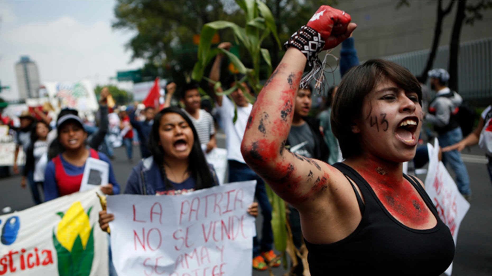 Protestors chant during a march commemorating the anniversary of the Tlatelolco Massacre, in Mexico City, Sunday, Oct. 2, 2016. Every year Mexico marks the anniversary of the 1968 massacre where students and civilians were killed by the military and police.(AP Photo/Rebecca Blackwell)