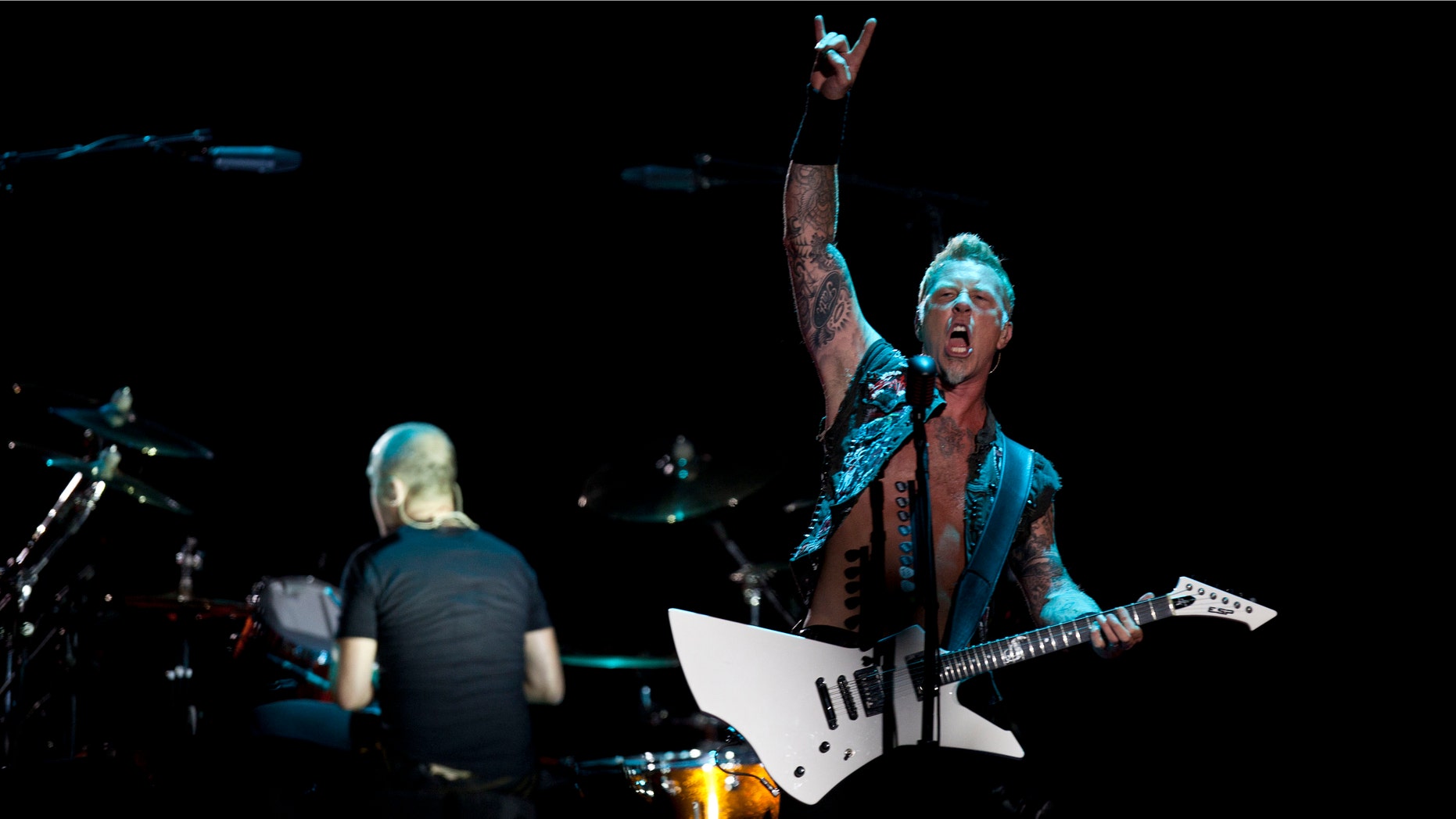 James Hetfield, lead singer for the heavy metal rock band "Metallica" performs during a concert at the Sports Palace, in Mexico City, Saturday, July 28, 2012. (AP Photo/Christian Palma)