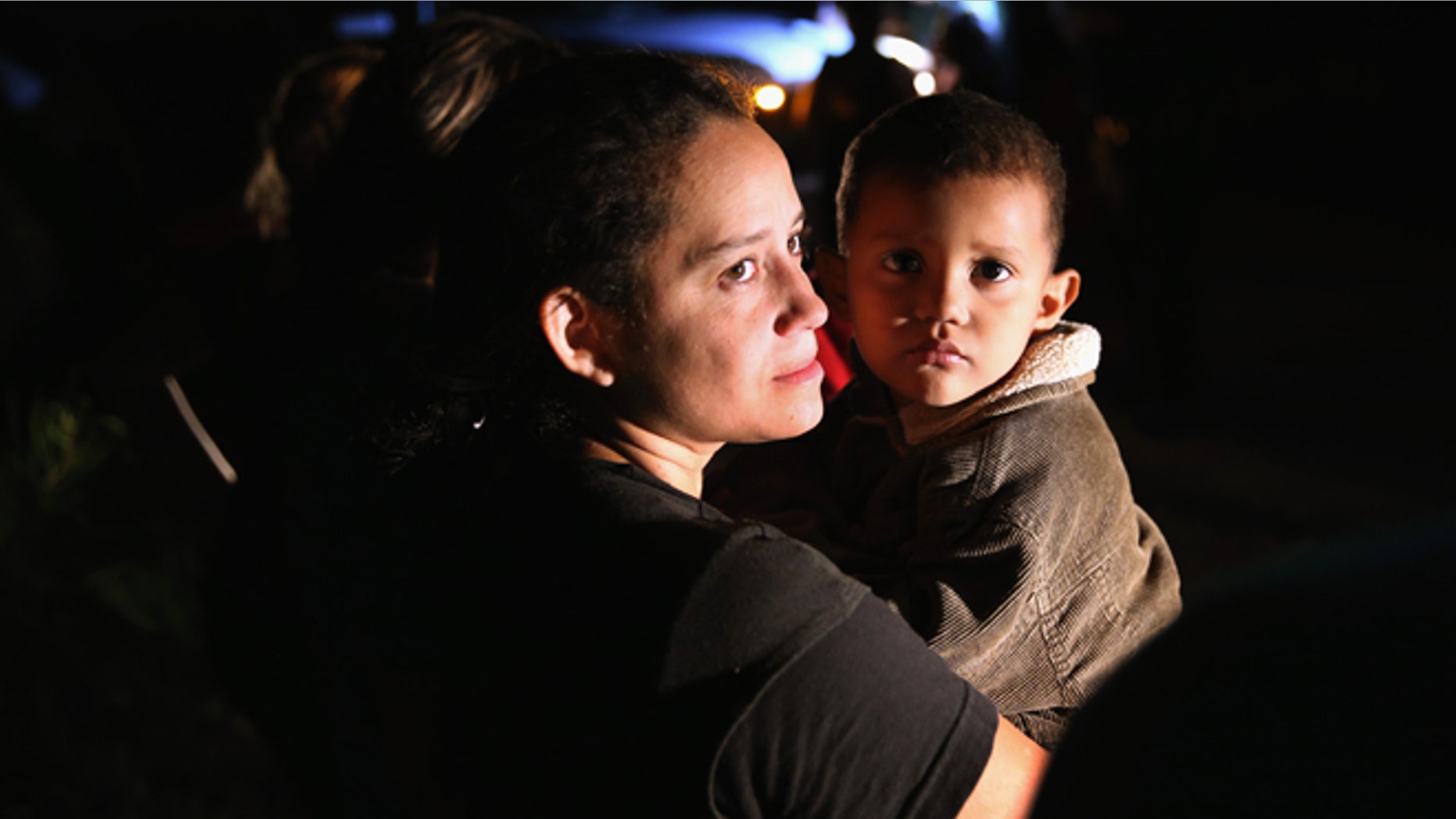 MISSION, TX - SEPTEMBER 08: Families of Central American immigrants, including Jamie Gonzales, 26, and her son Jose Manuel, 4, from El Salvador, turn themselves in to U.S. Border Patrol agents after crossing the Rio Grande River from Mexico on September 8, 2014 to Mission, Texas. Although the numbers of such immigrant families and unaccompanied minors have decreased from a springtime high, thousands continue to cross in the border illegally into the United States. The Rio Grande Valley sector is the busiest area for illegal border crossings, especially for Central Americans, into the U.S. (Photo by John Moore/Getty Images)