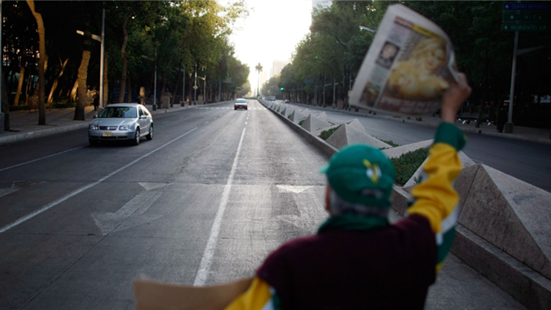 MEXICO CITY - MAY 01: A newspaper vendor has few sales as vehicle traffic is light due to the beginning of a national holiday and the government advising people to stay home in hopes of containing the swine flu on May 1, 2009 in Mexico City, Mexico. Cases of swine flu, the strain known as H1N1 virus, have been confirmed in nine countries, including Mexico, where at least 2,400 are believed to be infected, with the number of deaths attributed to the virus believed to be more than 150. The World Health Organization today raised the threat level to 'phase 5,' indicating a 'pandemic is imminent. (Photo by Joe Raedle/Getty Images)