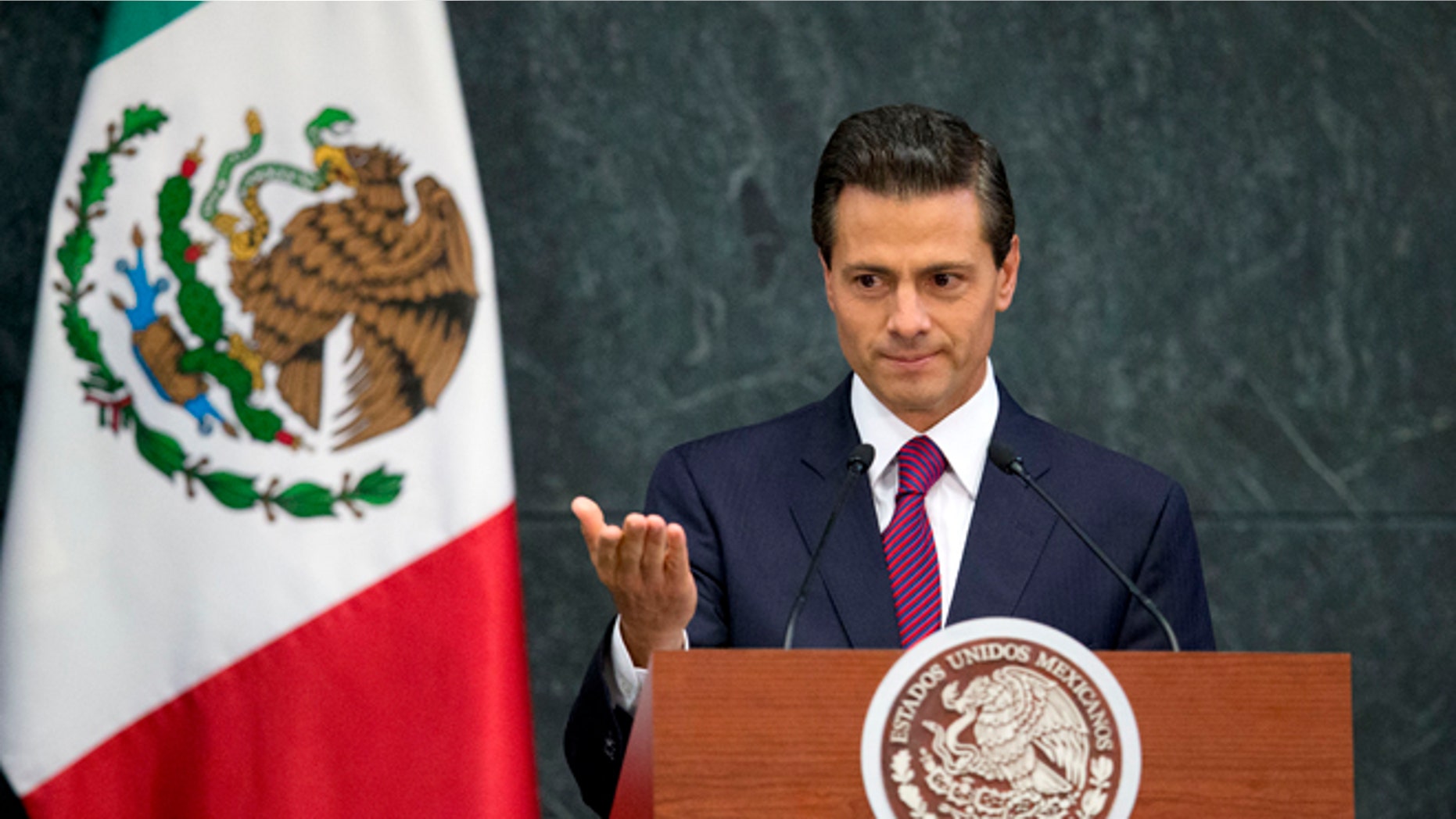 FILE - In this Aug. 27, 2015 file photo, Mexico's President Enrique Pena Nieto speaks during a press conference to announce cabinet changes, at the Los Pinos presidential residence, in Mexico City. Pena Nieto is set to deliver his third state-of-the-nation address on Wednesday, Sept. 2, 2015, amid rising violence, a falling currency and a slowing economy. Pena Nieto shook up his cabinet last week in an apparent attempt to change direction. But tough international market conditions may limit his maneuvering room. (AP Photo/Rebecca Blackwell, File)