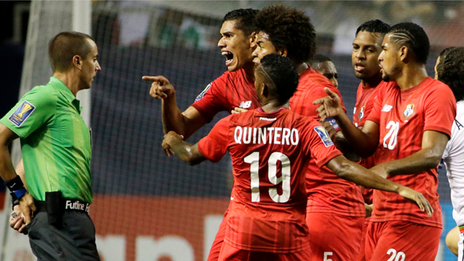 Panama's Valentin Pimentel, center right, points at referee Mark Geiger, who had given a red card to Panama's Luis Tejada, not seen, during the first half of Panama's CONCACAF Gold Cup soccer semifinal against Mexico on Wednesday, July 22, 2015, in Atlanta. (AP Photo/David Goldman)