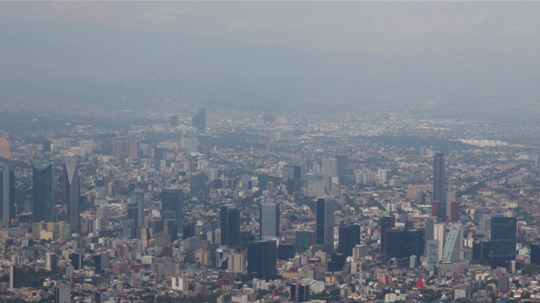 FILE - In this March 18, 2016, file photo, view shows Mexico City covered in smog a day after a pollution alert was lifted. Mexico City authorities have declared a pollution alert on Monday, May 2, 2016, after smog rose to 1½ times acceptable limits for second time in less than a month. (AP Photo/Rebecca Blackwell, File)