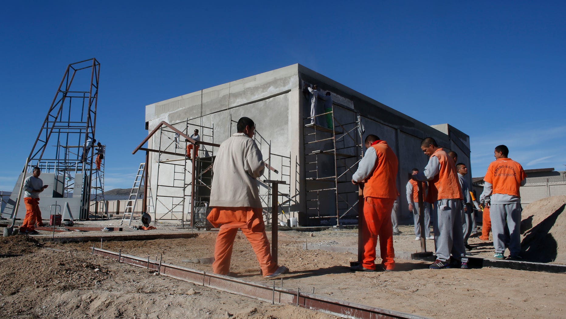 Inmates work construction inside the state prison in Ciudad Juarez, Sunday, Jan. 17, 2016.