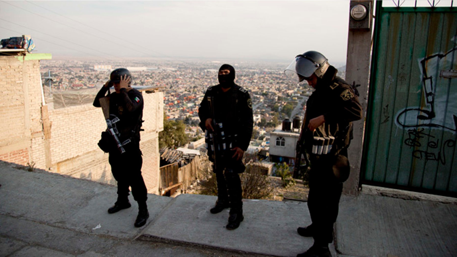 In this Jan. 19, 2015 photo, police officers prepare for an security operation in Ecatepec, a rough neighborhood on the outskirts of Mexico City. Pope Francis will hold the largest public event of his visit to Mexico when he celebrates Mass on an outdoor esplanade in Ecatepec on Feb. 14, 2016. (AP Photo/Eduardo Verdugo)