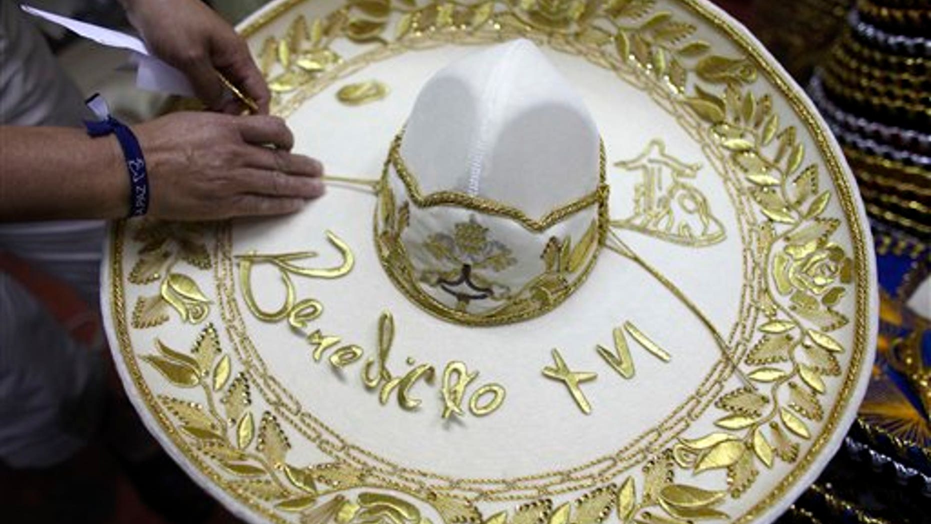 February 29, 2012: Maria de la Luz Yepes shows one of the sombrero's that will be given to Pope Benedict XVI, at her sombrero shop in the town of San Francisco del Rincon, near Leon, Mexico.