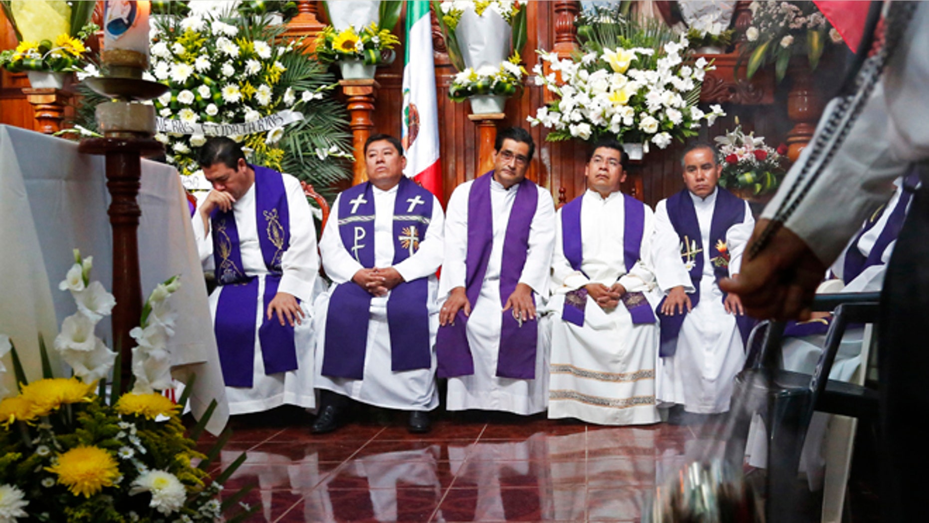 Priests attend the funeral Mass for slain Rev. Jose Alfredo Suarez in Paso Blanco, Veracruz, Mexico, Sept. 21, 2016.