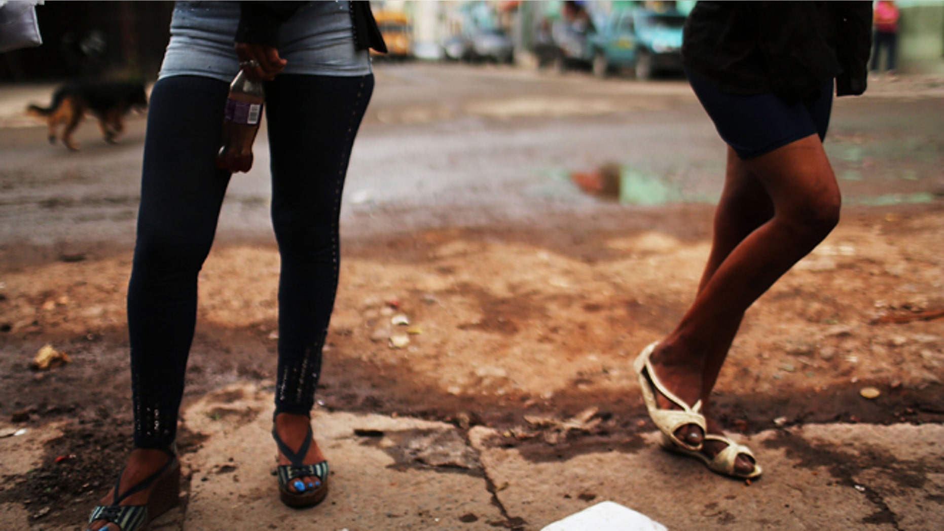 TEGUCIGALPA, HONDURAS - JULY 18: Sex workers wait for customers in a gang infested neighborhood on July 18, 2012 in Tegucigalpa, Honduras. Honduras now has the highest per capita murder rate in the world and its capital city, Tegucigalpa, is plagued by violence, poverty, homelessness and sexual assaults. With an estimated 80% of the cocaine entering the United States now being trans-shipped through Honduras, the violence on the streets is a spillover from the ramped rise in narco-trafficking. The non-governmental organization Doctors Without Borders has set up a program in the capital that looks to provide medical and psychological care to the homeless population. Each day a team goes out into the streets to meet with vulnerable groups of homeless to assess their needs. (Photo by Spencer Platt/Getty Images)