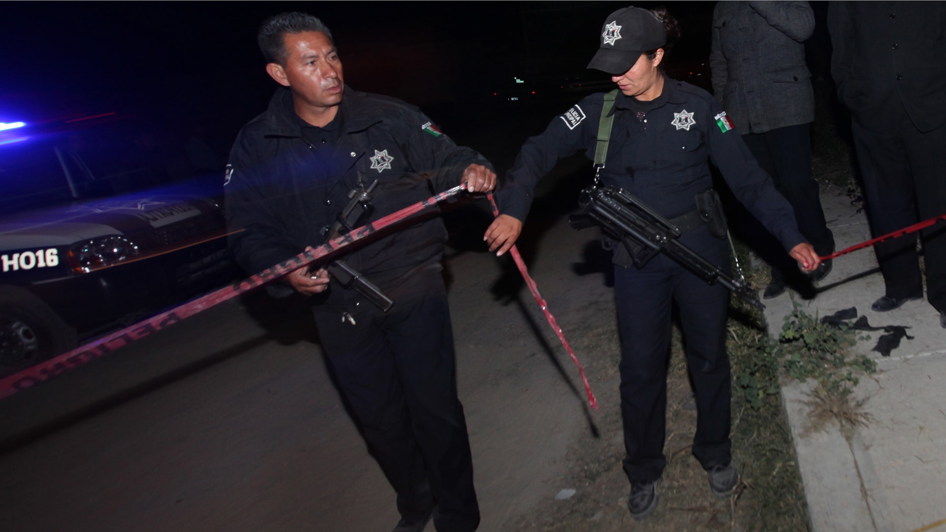 Police agents cordon off an area in the village of Hueypoxtla, Mexico, Wednesday, Dec. 4, 2013. Mexican troops and federal police kept a nighttime vigil guarding a rural field where thieves abandoned a stolen shipment of highly radioactive cobalt-60, while officials began planning the delicate task of safely recovering the dangerous material. The cargo truck hauling the cobalt-60 was stolen from a gas station Tuesday in the neighboring state of Hidalgo, about 40 kilometers (24 miles) from where the material was recovered. (AP Photo/Marco Ugarte)