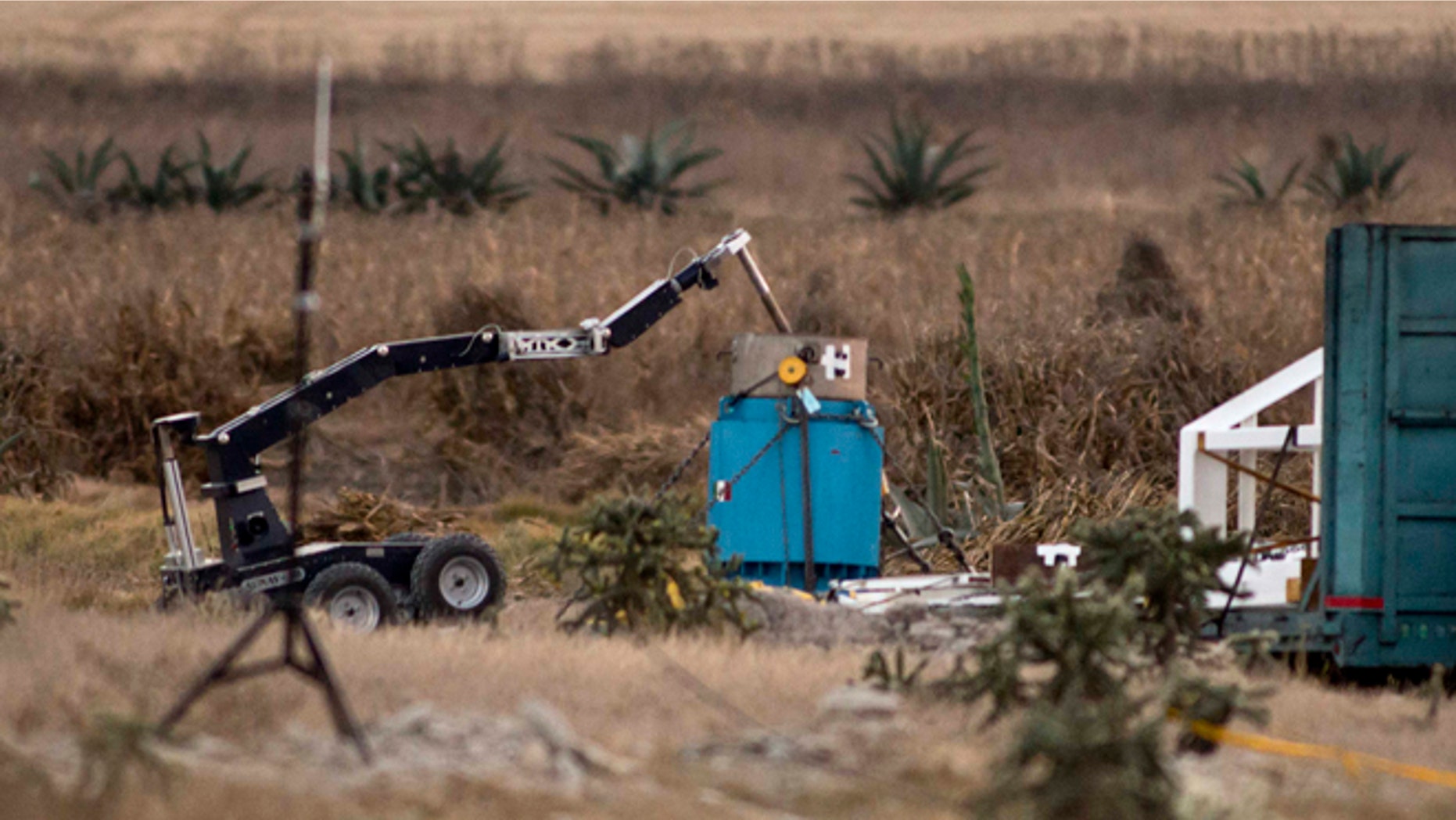 A robotic arm recovers radioactive cobalt-60 and deposits it in a safe container on a field in the town of Hueypoxtla, central Mexico, Tuesday Dec. 10, 2013.