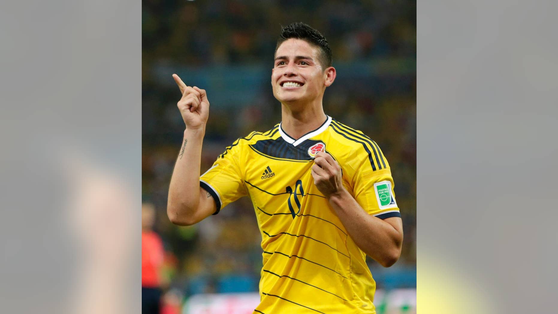 FILE - In this June 28, 2014, file photo, Colombia's James Rodriguez celebrates after he scored his side's second goal during the World Cup round of 16 soccer match between Colombia and Uruguay at the Maracana Stadium in Rio de Janeiro, Brazil. The 23-year-old Monaco forward who was the top scorer at the World Cup, is closing in on a deal with Real Madrid. Spanish sports newspapers said Monday that Monaco had agreed terms with Madrid and Rodriguez is to be presented to fans on Tuesday. (AP Photo/Marcio Jose Sanchez,File)