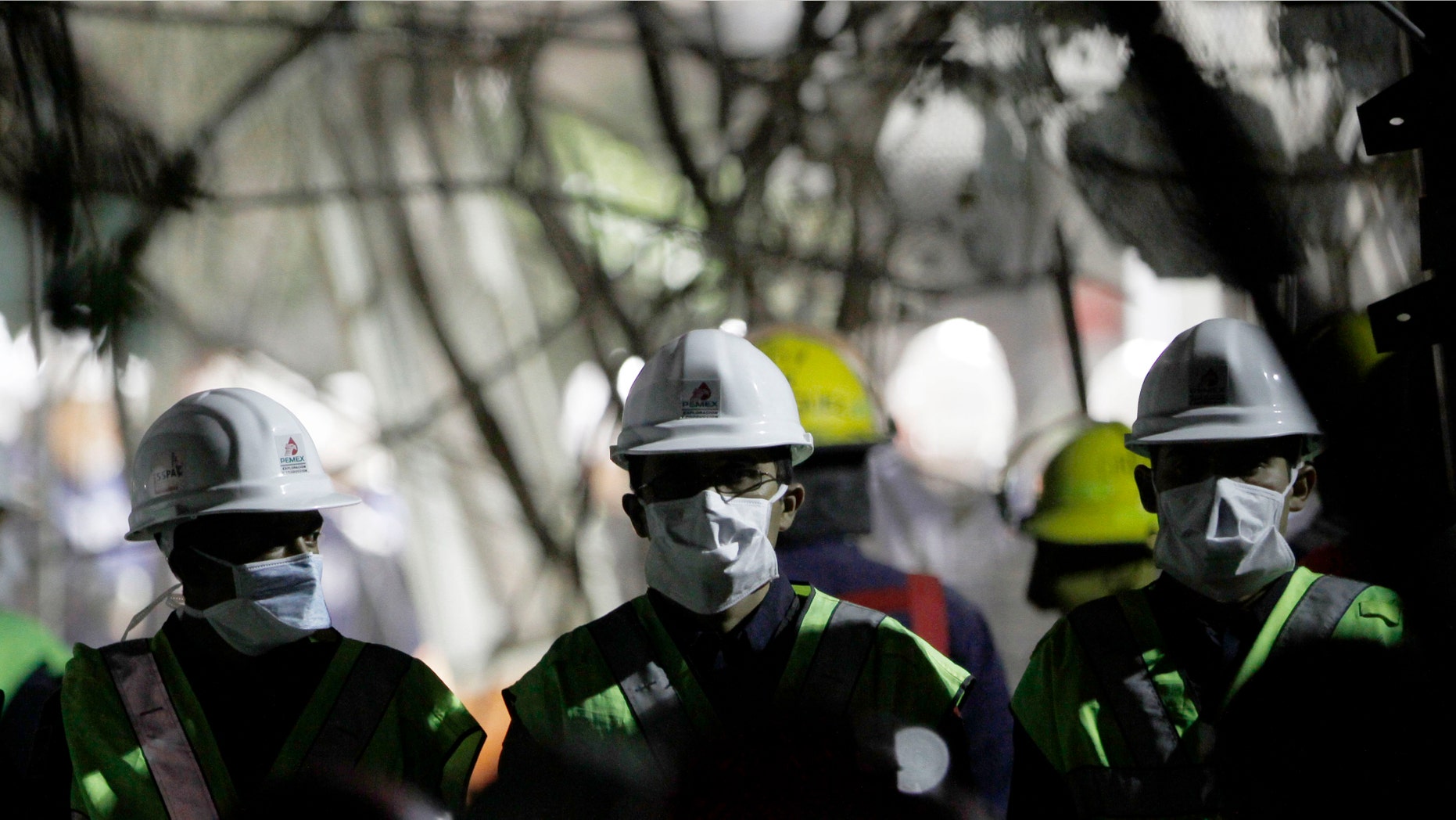 Employees cull through debris searching for office documents amid the rubble left from an office building explosion in Mexico City, Feb. 2. The death toll is now at 37.