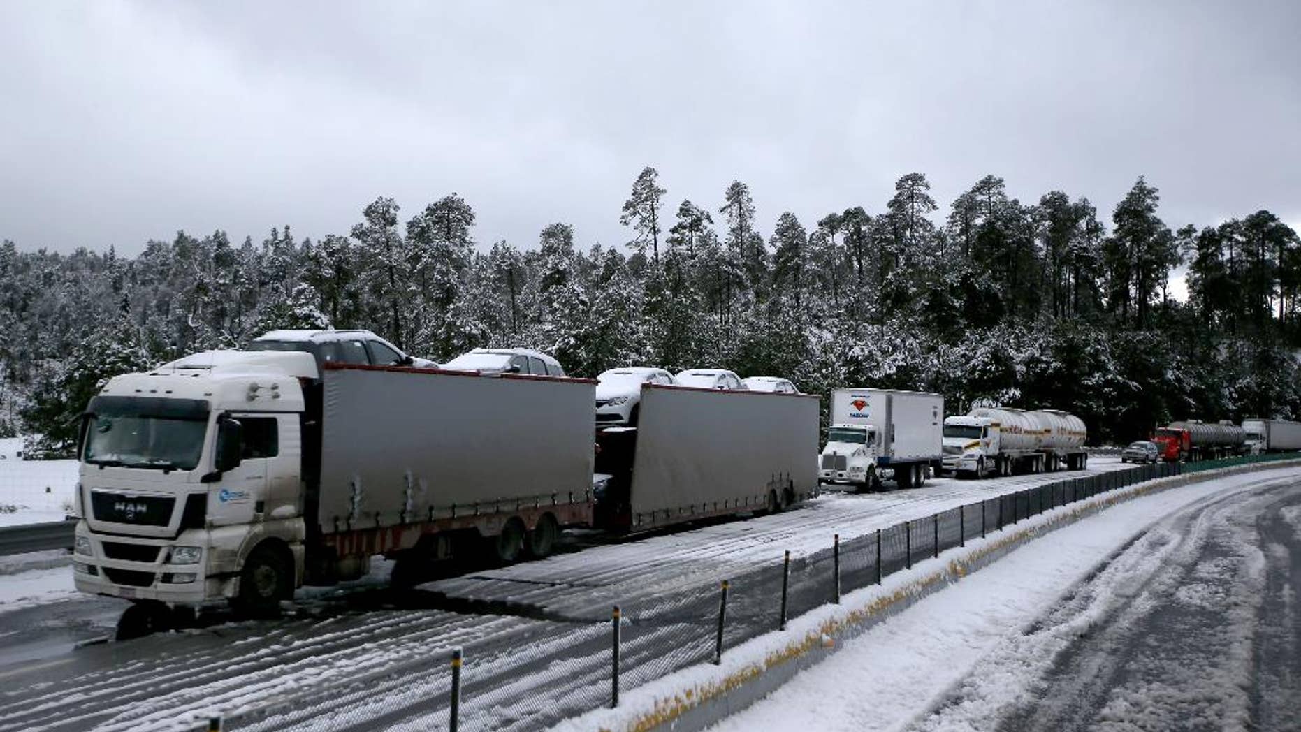 Traffic stands still due to snow, in Rio Frio, Mexico, Thursday, March 12, 2015. One of the main access roads to the city of Mexico was closed on Thursday after a snowstorm in the mountainous area east of the capital which reached unusual levels. (AP Photo)