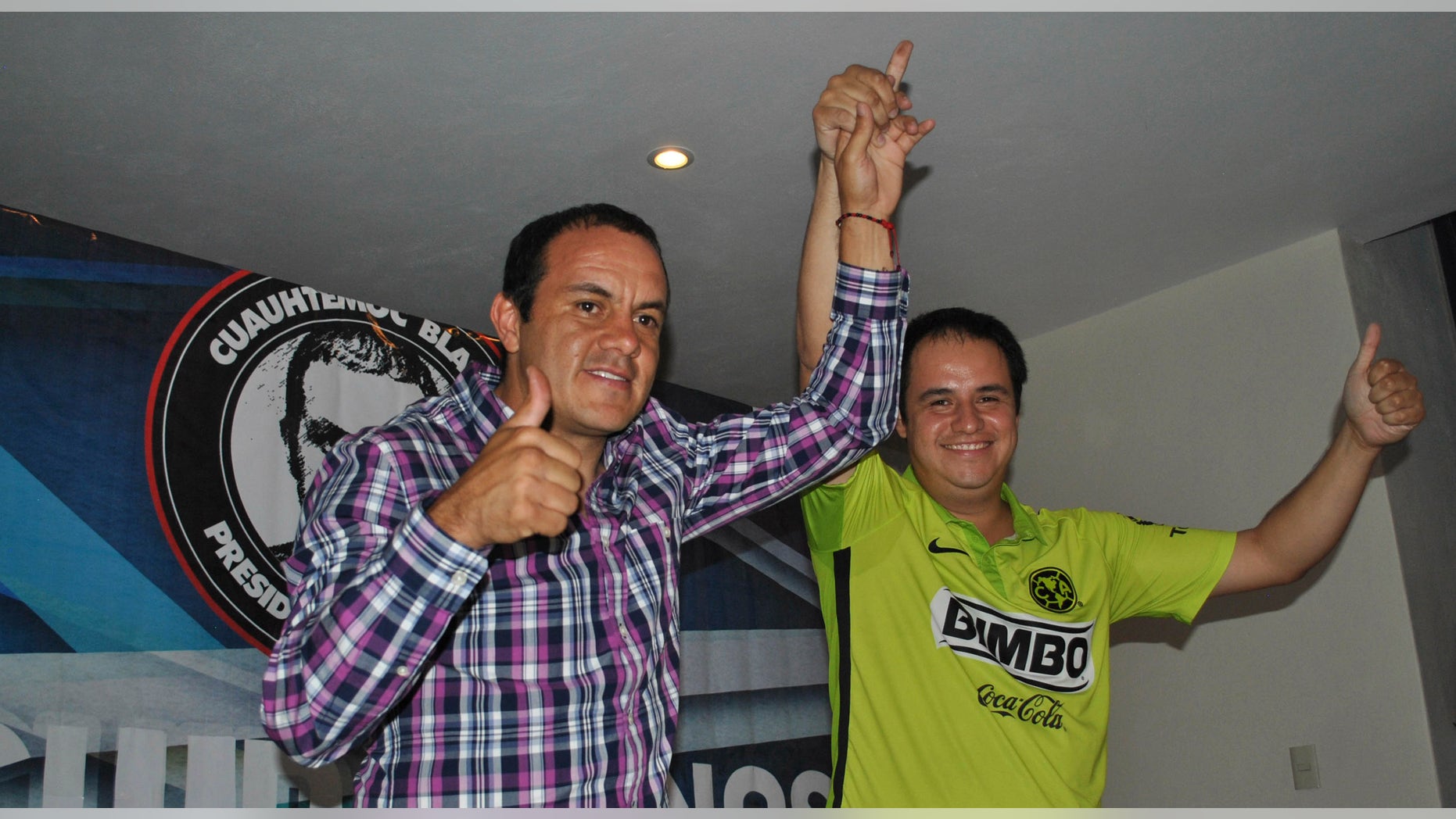 Cuauhtemoc Blanco, left, gives the thumbs up during election day Sunday, June 7, 2015.