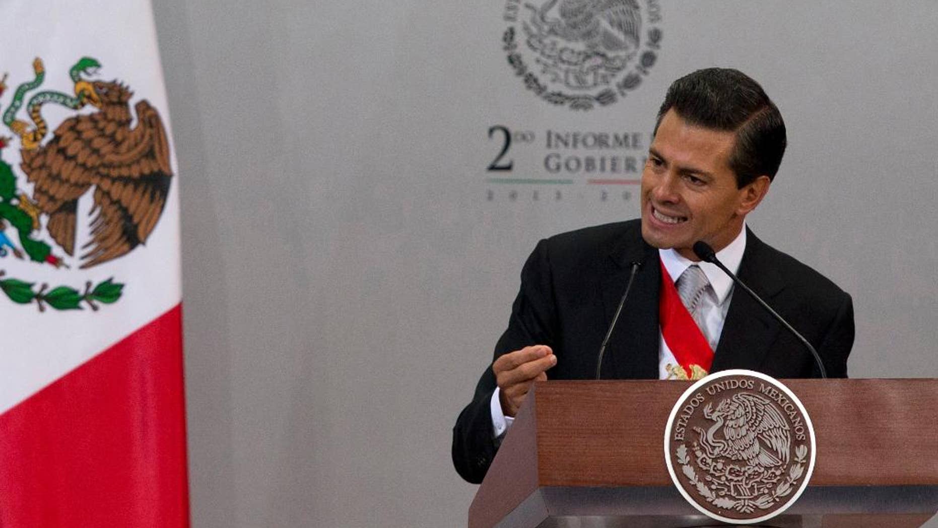 FILE - In this Sept. 2, 2014 file photo, Mexico's President Enrique Pena Nieto gives his second state-of-the-nation address inside the National Palace in Mexico City. The Mexican president said in an interview with the newspaper El Universal published Friday, Sept 12, 2014, that Texas' decision to deploy National Guard troops along the border is "unpleasant" and "reprehensible," and could affect bilateral relations. (AP Photo/Eduardo Verdugo, File)