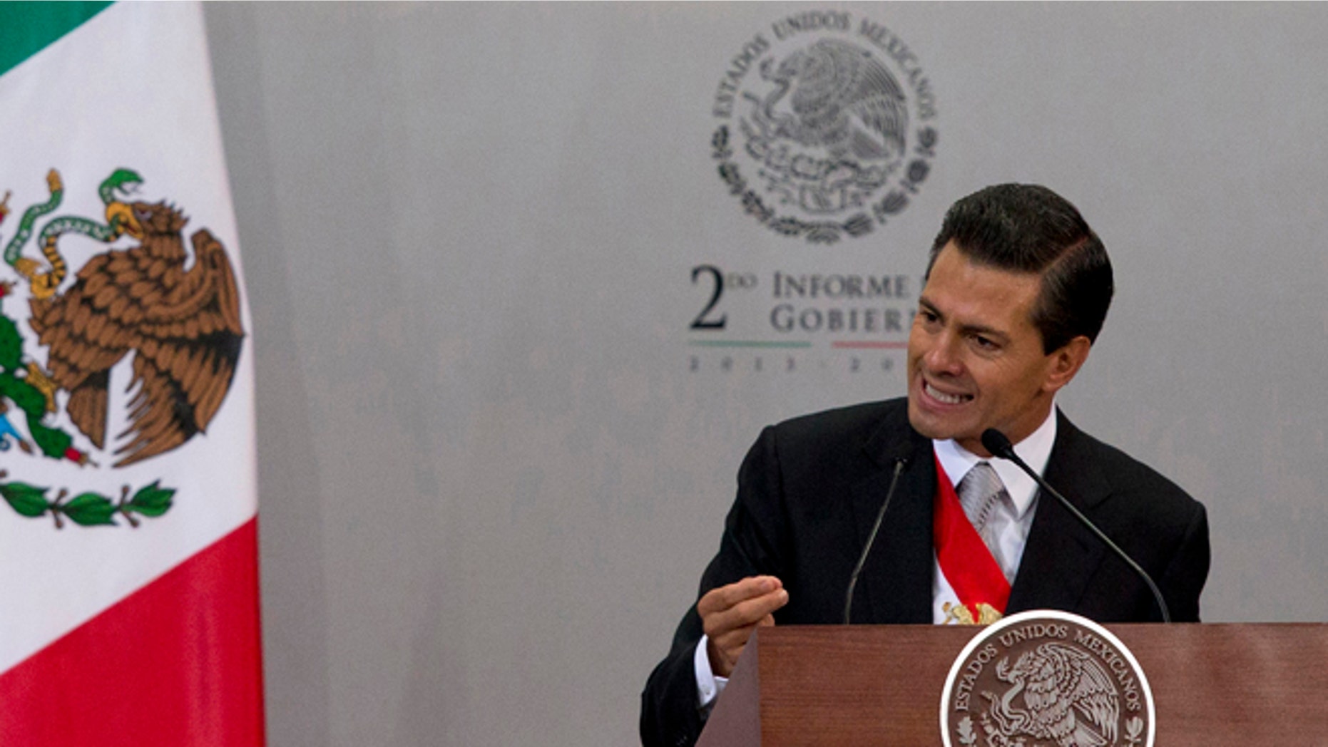 FILE - In this Sept. 2, 2014 file photo, Mexico's President Enrique Pena Nieto gives his second state-of-the-nation address inside the National Palace in Mexico City. The Mexican president said in an interview with the newspaper El Universal published Friday, Sept 12, 2014, that Texas' decision to deploy National Guard troops along the border is "unpleasant" and "reprehensible," and could affect bilateral relations. (AP Photo/Eduardo Verdugo, File)