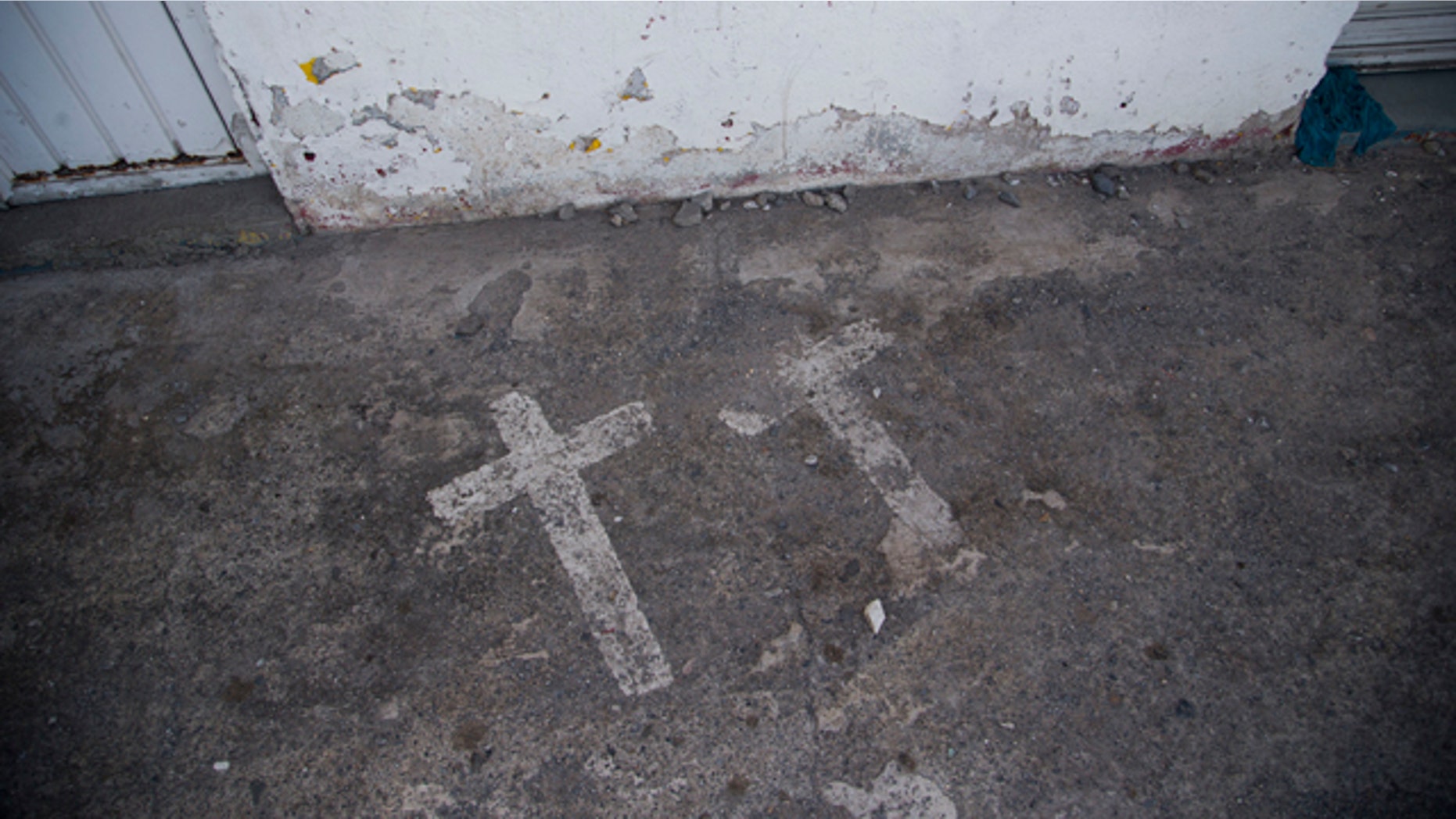 In this Aug. 19, 2015 photo, painted crosses mark the site where two college students were killed and 43 more kidnapped, in Iguala, Mexico on Sept. 26, 2014. According to a federal investigation, the students were taken by police and then handed over to a local drug gang that allegedly killed them and burned the bodies. (AP Photo/Dario Lopez-Mills)