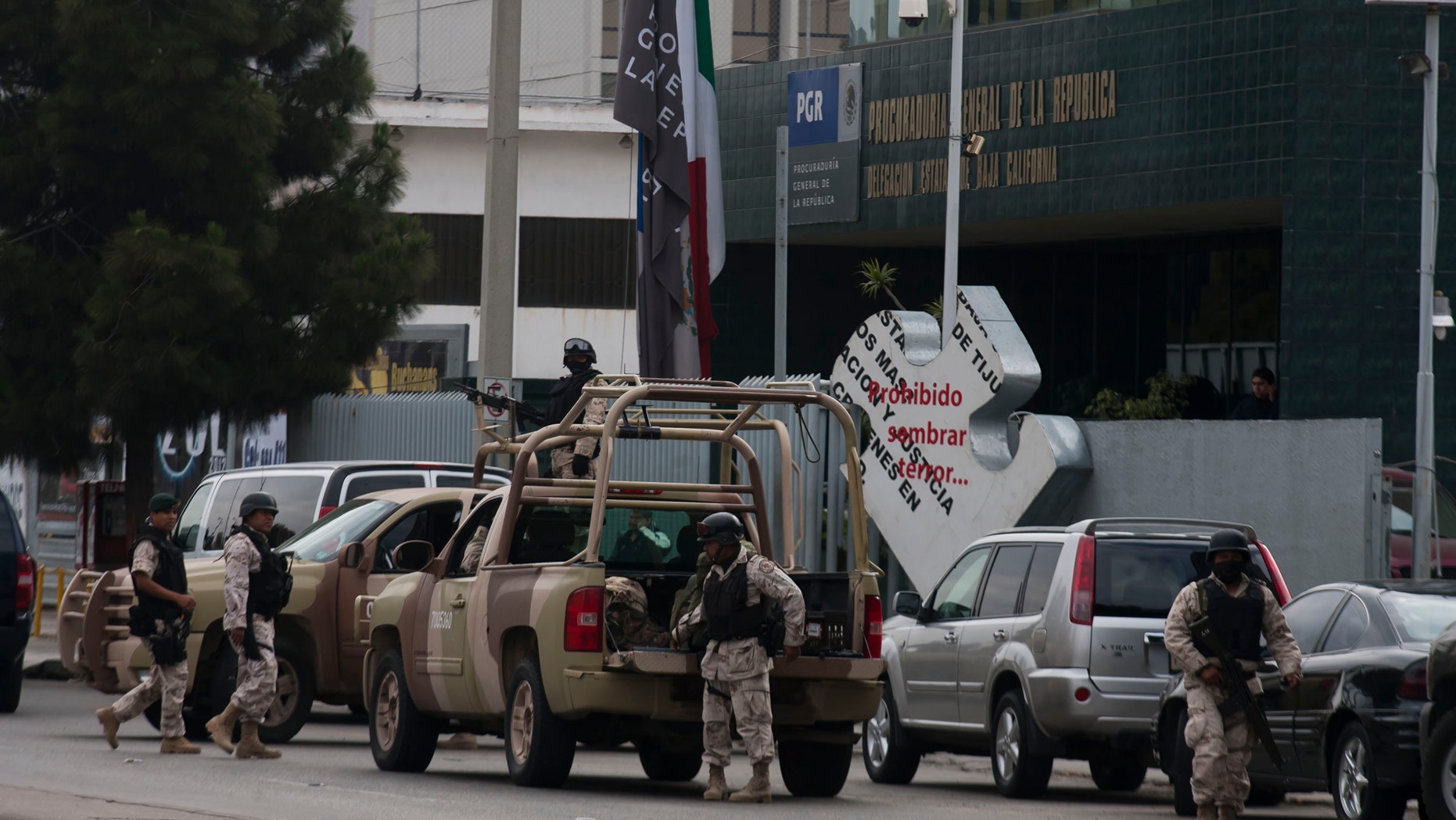 Mexican army soldiers guard the perimeter around the regional Attorney General's office after the early morning arrest of former Tijuana Mayor Jorge Hank Rohn in the city of Tijuana, Mexico Saturday June 4, 2011. Hank Rhon, one of Mexico's most flamboyant businessmen and politicians, has been detained on suspicion of illegal weapons possession, the federal Attorney General's Office has announced.