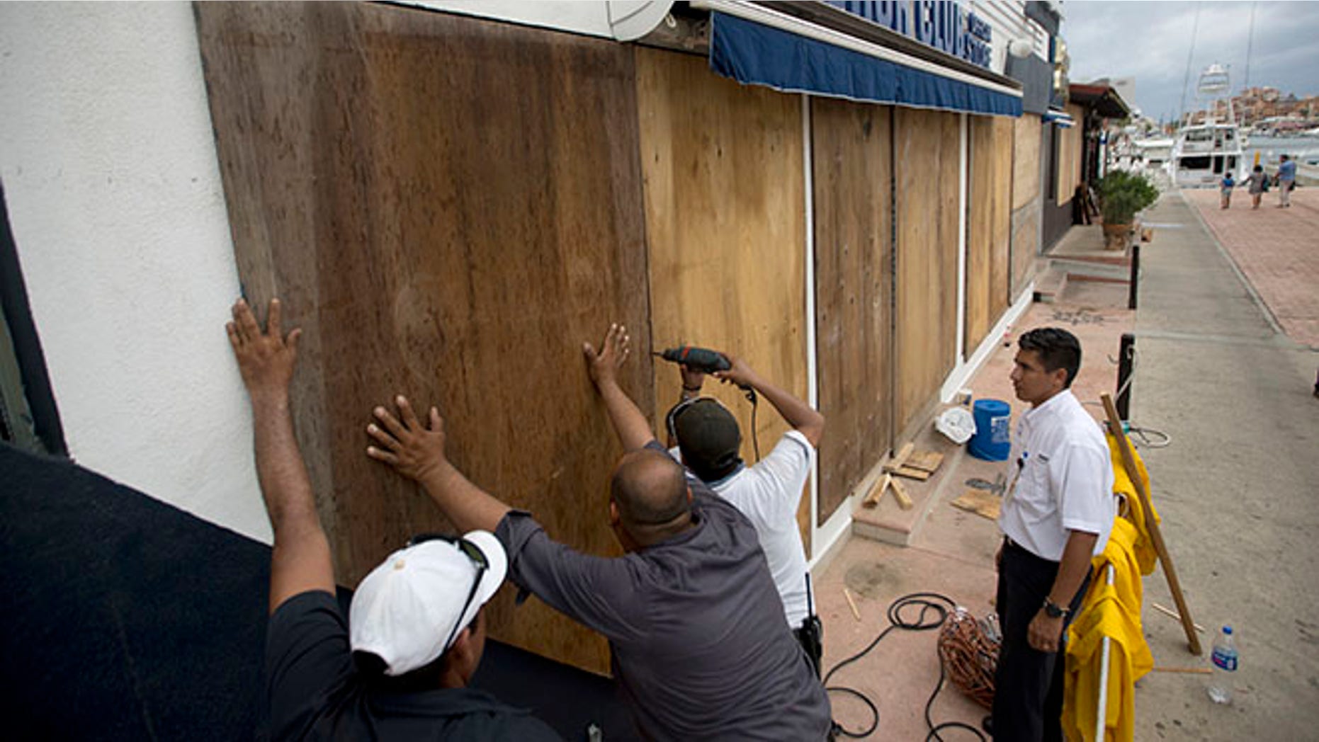 Workers board over a store front in preparation for Hurricane Newton, in Cabo San Lucas, Mexico, Monday Sept. 5, 2016. Authorities at the southern end of Mexico's Baja California peninsula ordered schools closed and set up emergency shelters as Hurricane Newton gained strength while bearing down on the twin resorts of Los Cabos for a predicted arrival Tuesday morning. (AP Photo/Eduardo Verdugo)