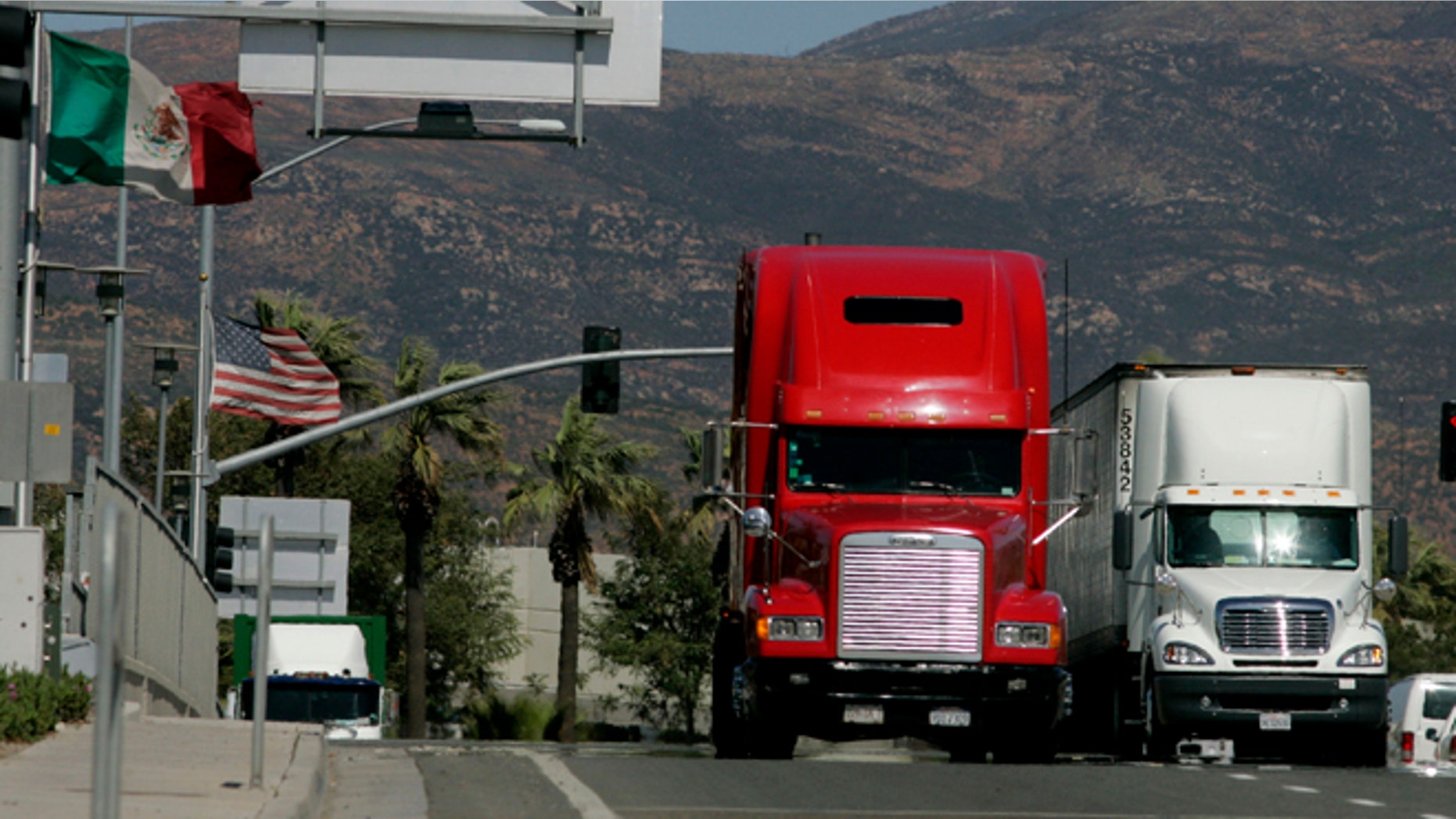 OTAY MESA, CA-MARCH 24: Trucks coming from Mexico prepare to enter the highway after crossing the border March 24, 2009 in Otay Mesa, California. Mexico last week slapped higher tariffs on an estimated $2.4 billion worth of goods entering the country from the U.S. in response to a move by Congress to end a pilot program allowing Mexican trucks to operate in the U.S. (Photo by Sandy Huffaker/Getty Images)