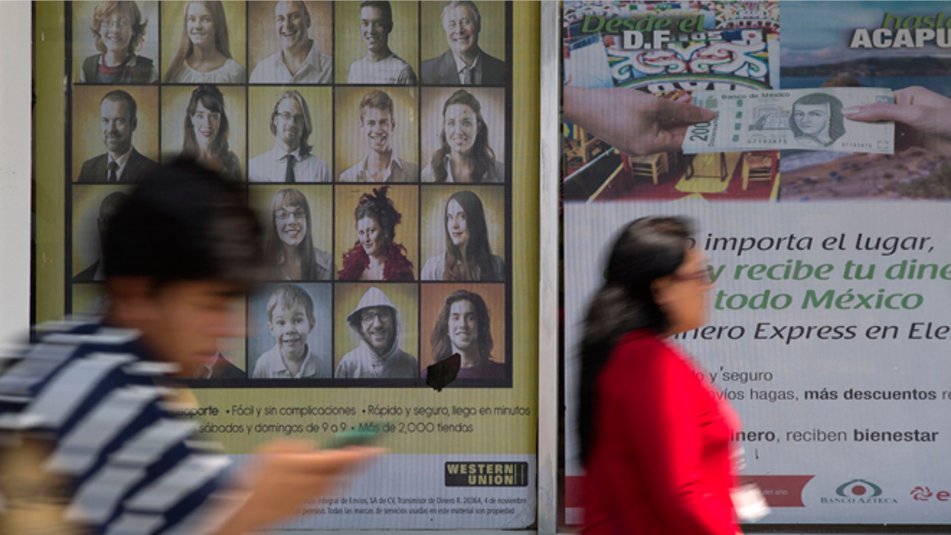People walk past signs advertising money transfer services outside a business in Mexico City, Tuesday, April 5, 2016. U.S. Republican Presidential frontrunner Donald Trump is threatening to block billions of dollars in U.S. remittances to force Mexico to pay for his proposed border wall. (AP Photo/Rebecca Blackwell)