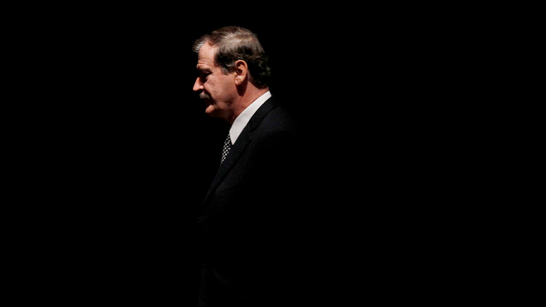 FILE - In this Oct. 18, 2011, file photo, former President of Mexico Vicente Fox walks on stage to speak at the CATO Institute in Washington. Mexicans backed former President Fox in his verbal spat with Donald Trump on Friday, Feb. 26, 2016, after Fox called the Republican front-runner crazy and a false prophet and Trump replied that he ought to be ashamed of himself. (AP Photo/Pablo Martinez Monsivais, File)