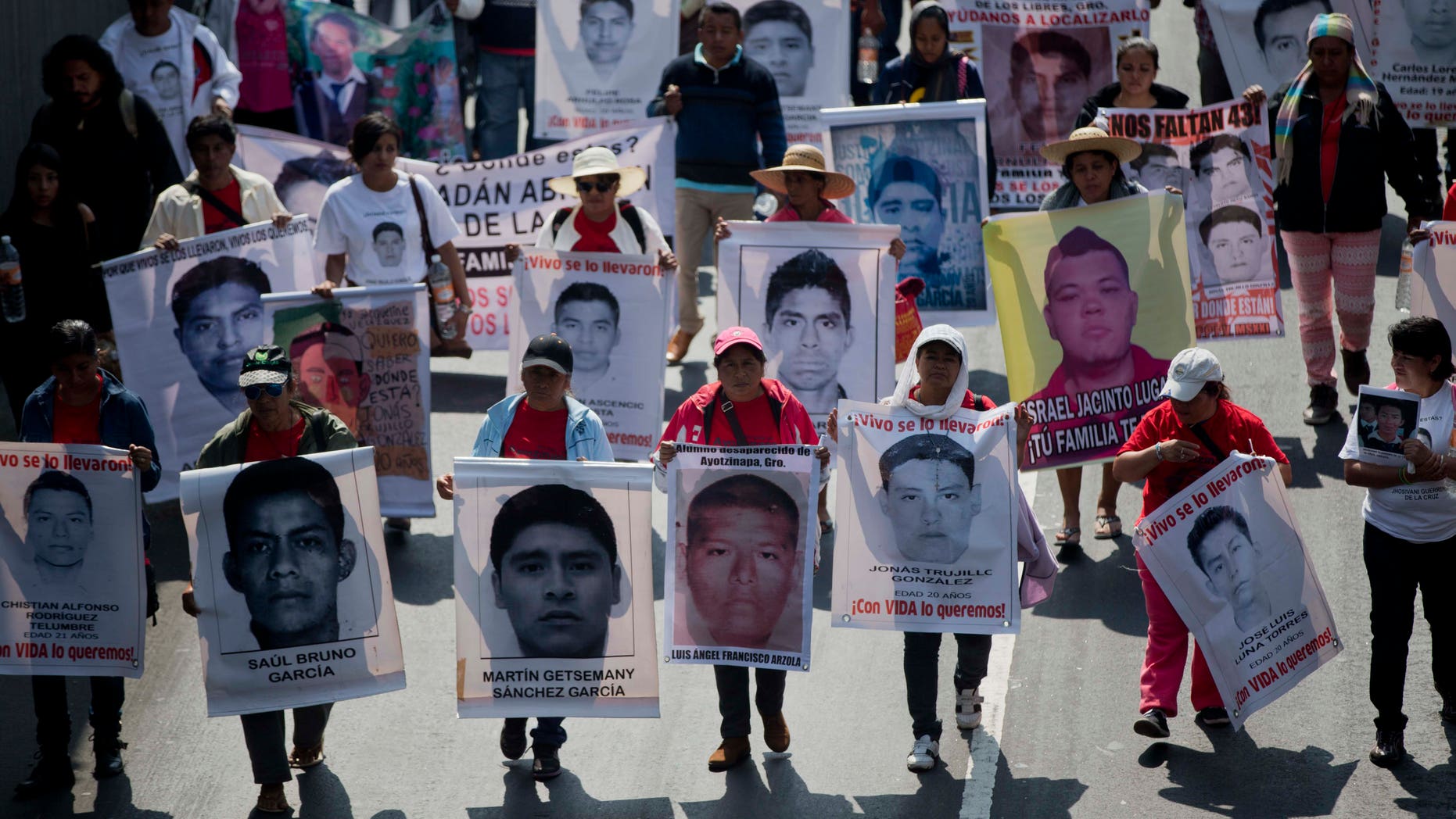 FILE - In this Jan. 26, 2015 file photo, relatives and protestors carry pictures of some of the 43 students who went missing in Sept. 26, 2014 from a rural teachers college in Guerrero state, during a march in Mexico City. Mexico has a serious problem with disappearances and lacks a comprehensive national list of the missing to effectively deal with the problem, according to a report the countrys National Human Rights Commission will present Monday, Feb. 2, 2015 to the U.N. (AP Photo/Eduardo Verdugo, File)