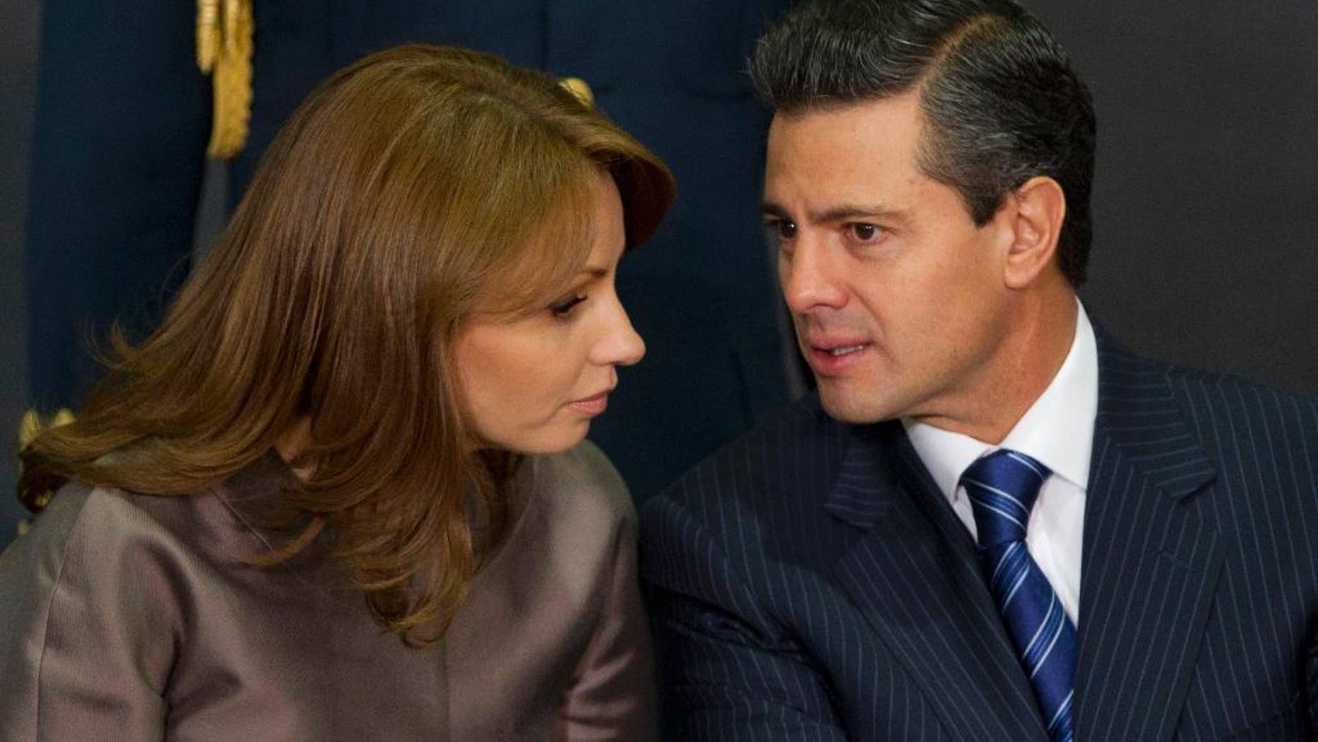 March 13, 2013: In this file photo, Mexico's President Enrique Pena Nieto, right, speaks to his wife Angelica Rivera as they attend a ceremony launching the program "Life insurance for female heads of family" at Los Pinos presidential residence in Mexico City. (AP)