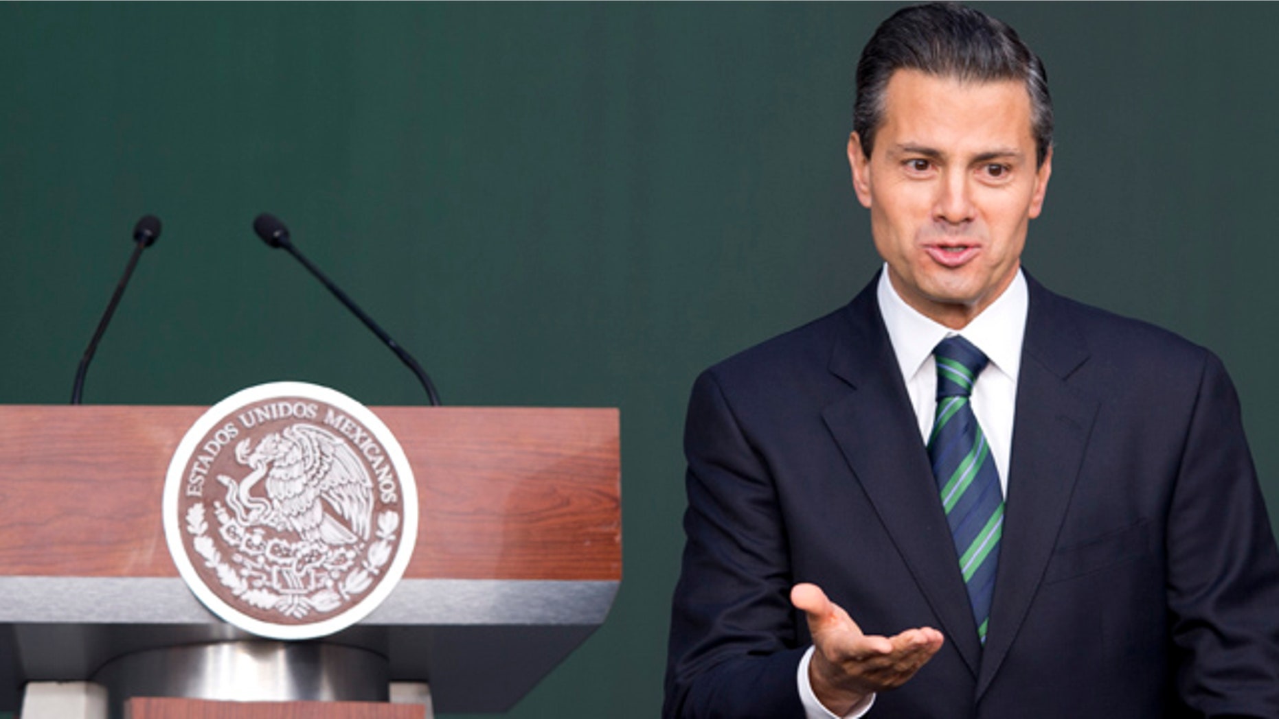 November 27, 2014: Mexico's President Enrique Pena Nieto gestures after addressing the audience during a ceremony at the National Palace in Mexico City. (AP Photo/Eduardo Verdugo)