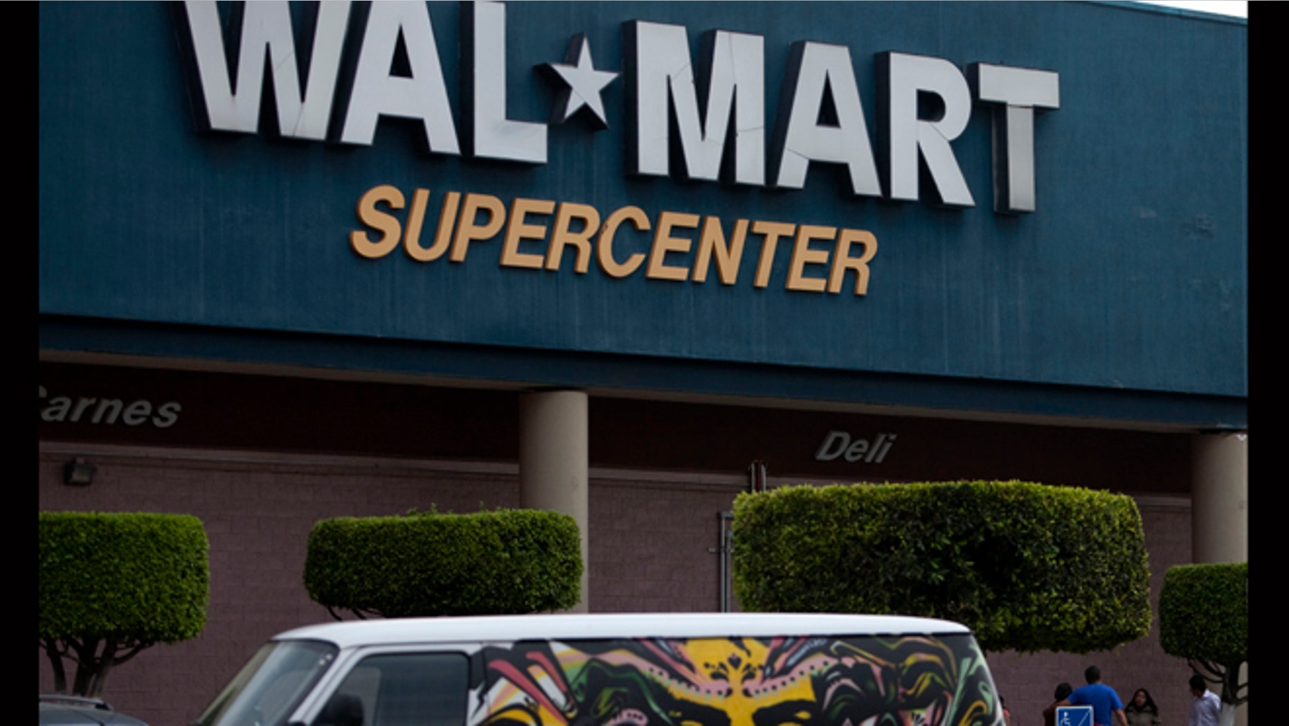 April 21, 2012: A van covered by a mural sits parked outside a Walt-Mart Super Center in Mexico City.